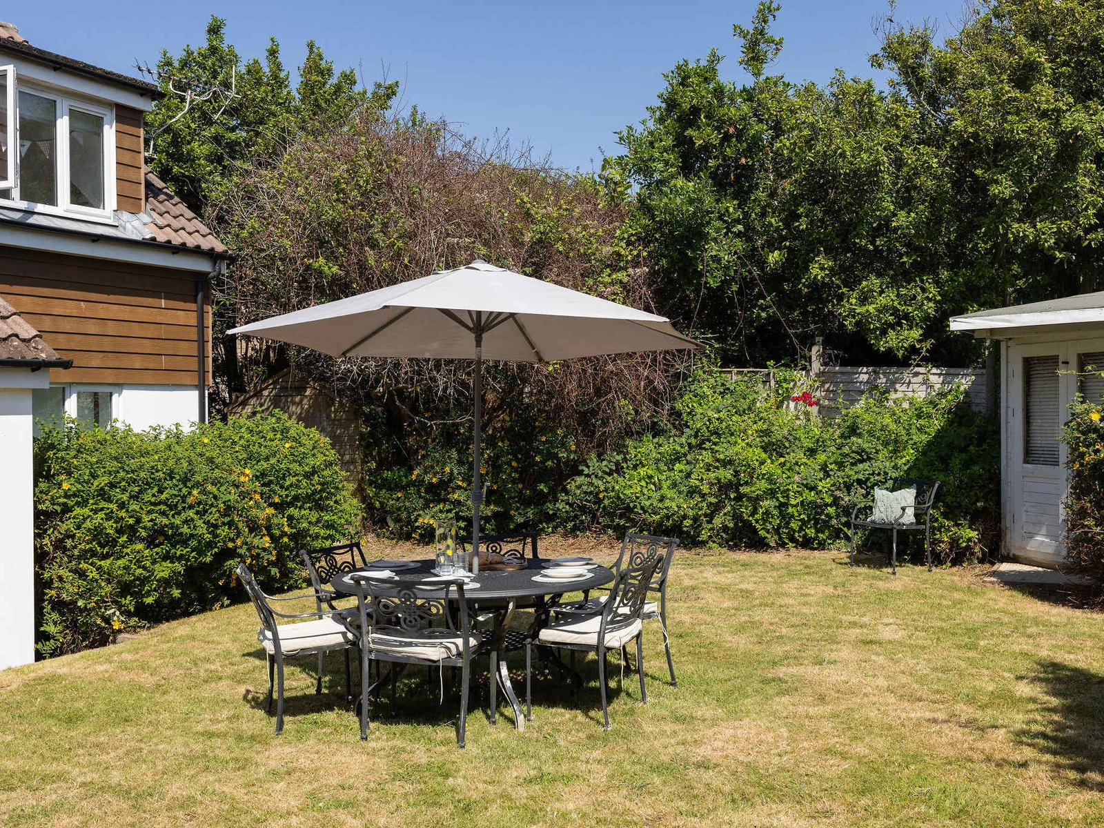 Enjoy outdoor dining in the spacious and sunny garden of this relaxing family getaway.