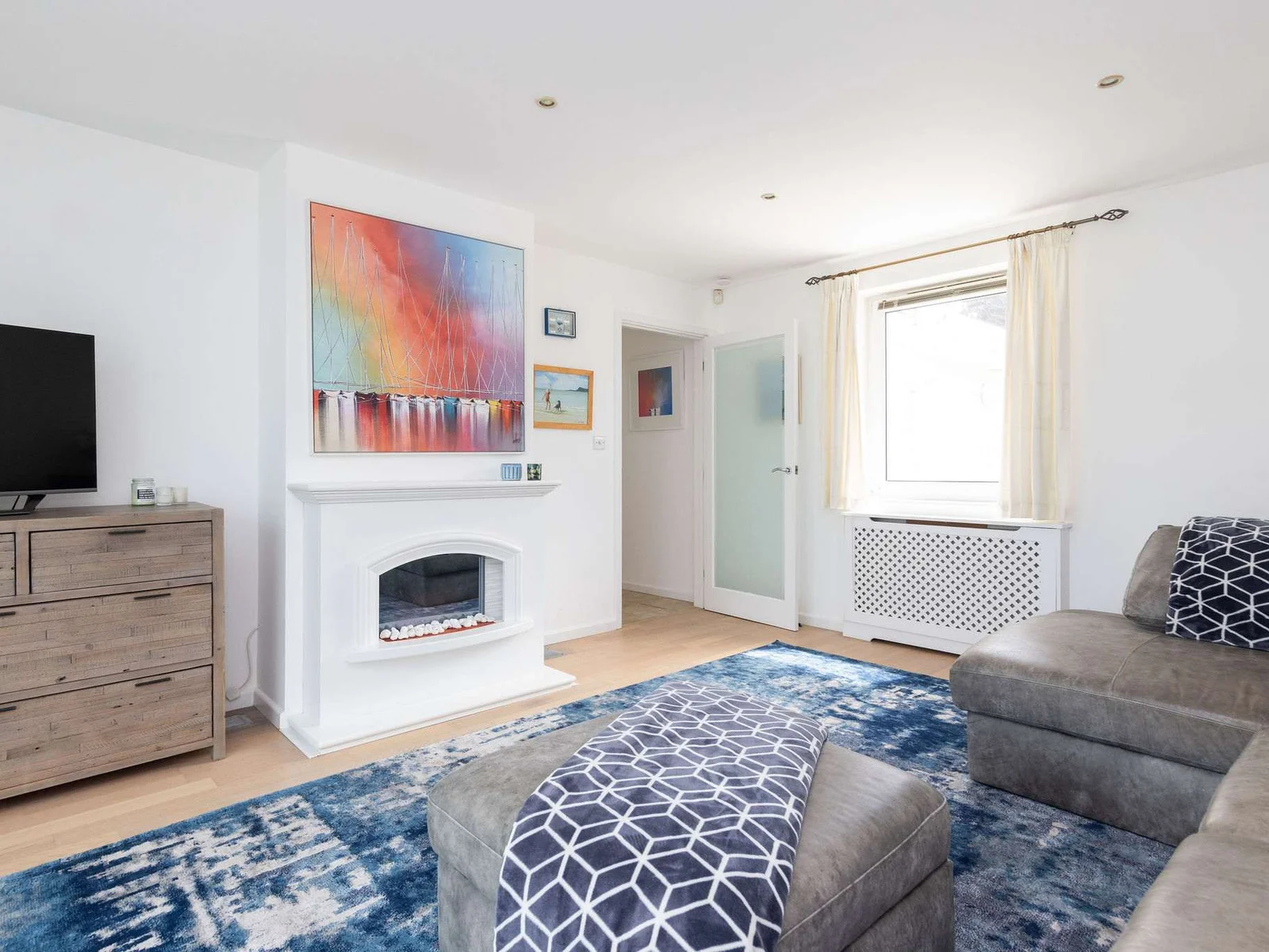 Cosy living room with stylish decor and electric fire