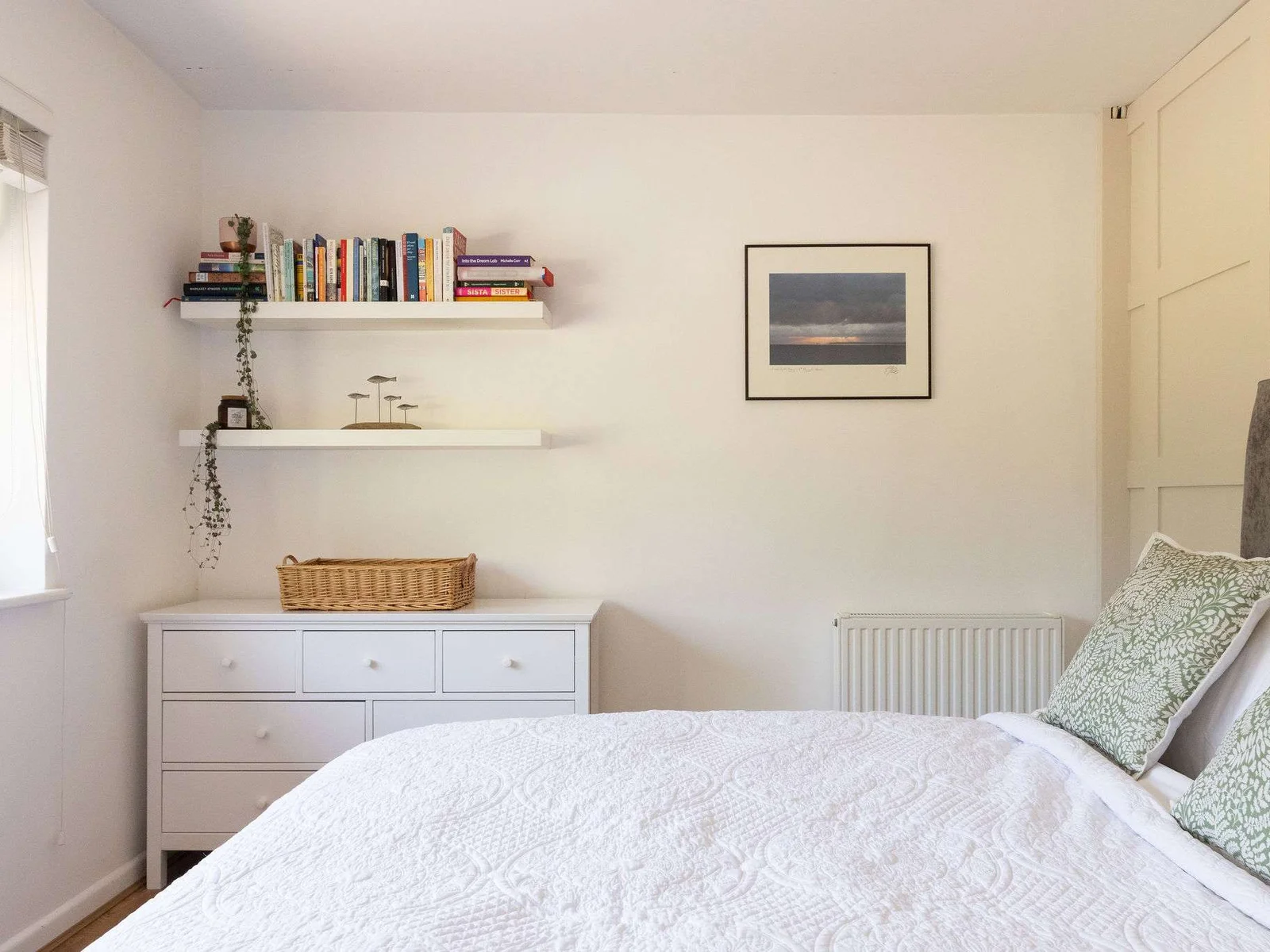 A peaceful double bedroom with soft, simple styling