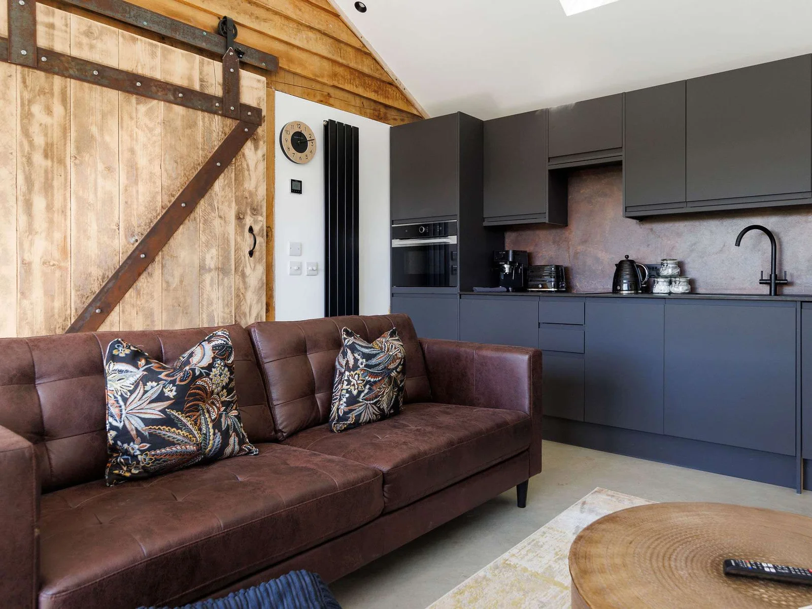 Relax on the large sofa in the living area, complete with comfy cushions.