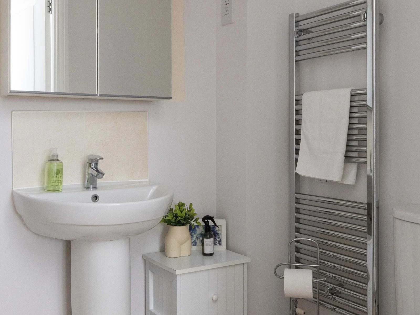 Bright ensuite with heated towel rail.
