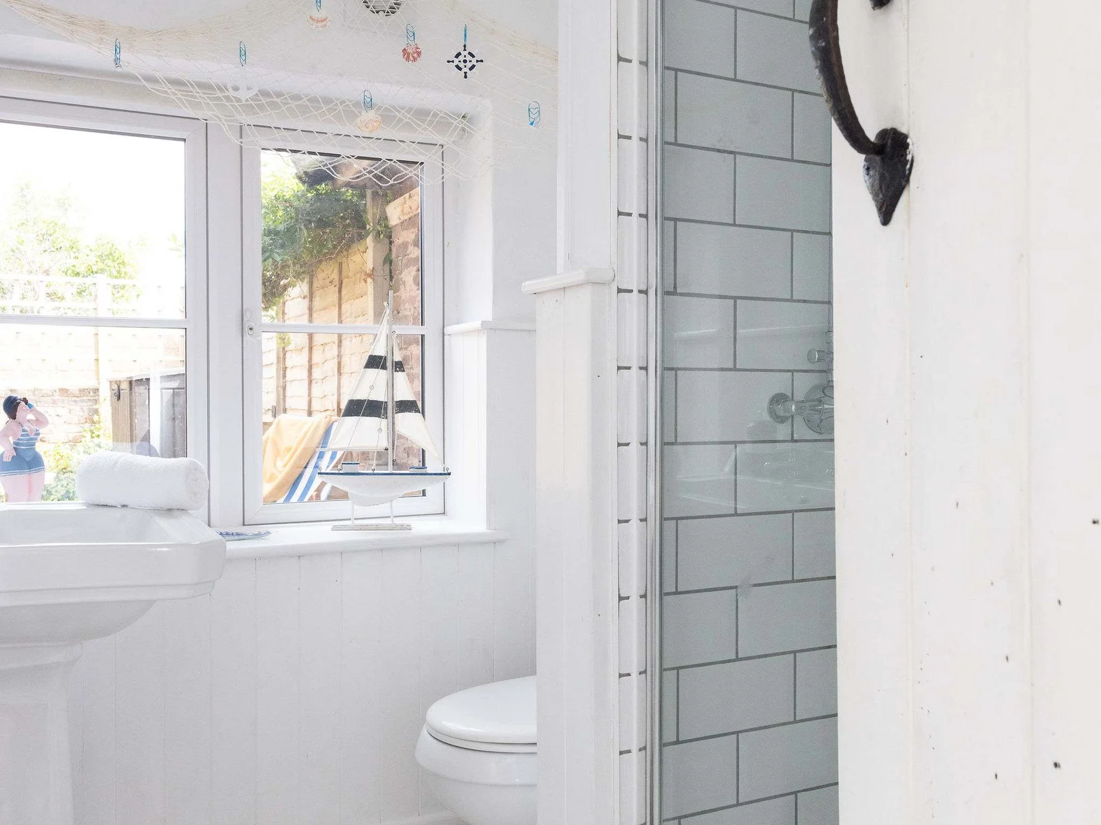 The bathroom has a walk in shower, sink and WC.