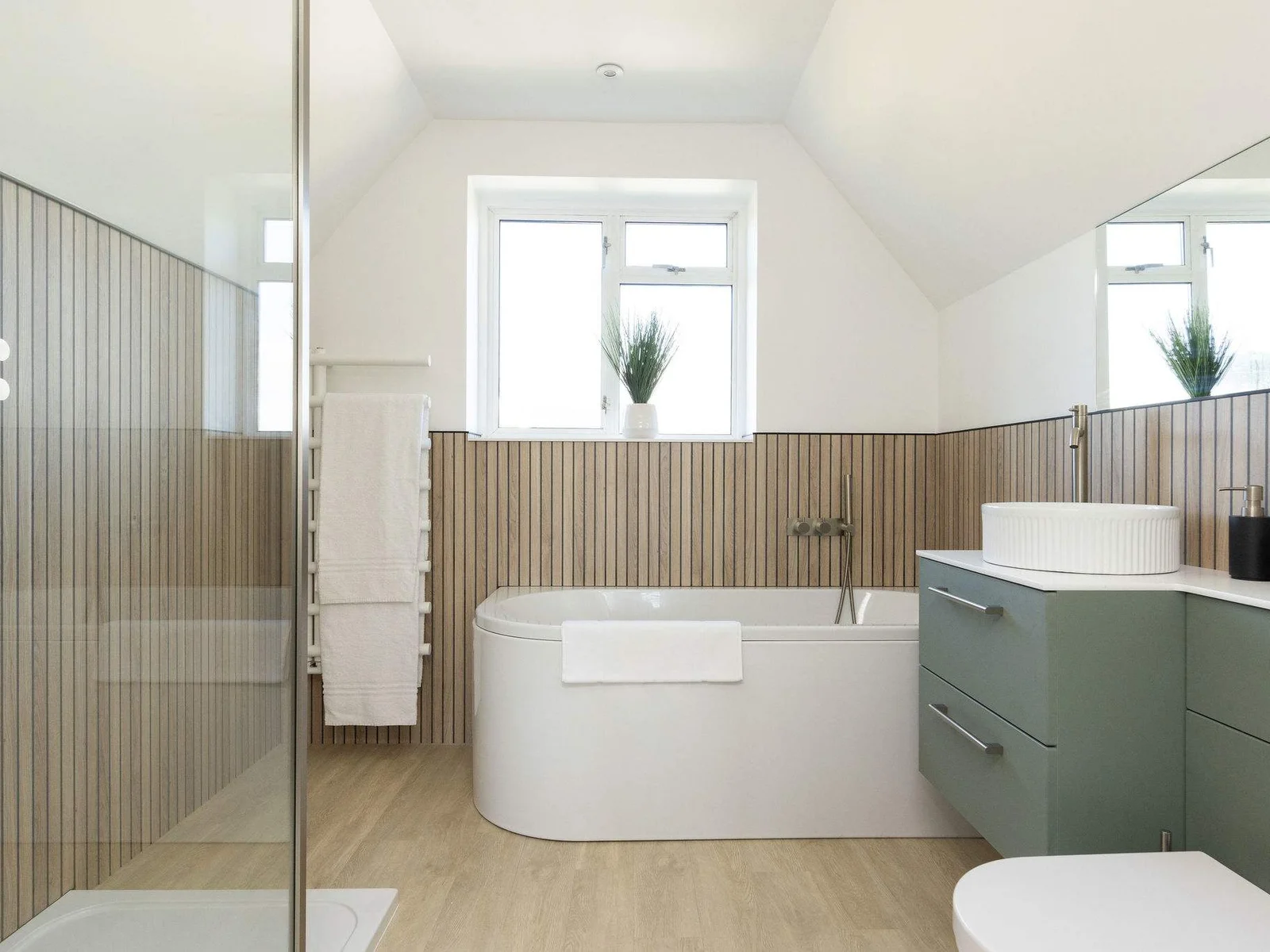 The main ensuite is hotel standard, with huge bath, walk-in shower and bespoke vanity unit.