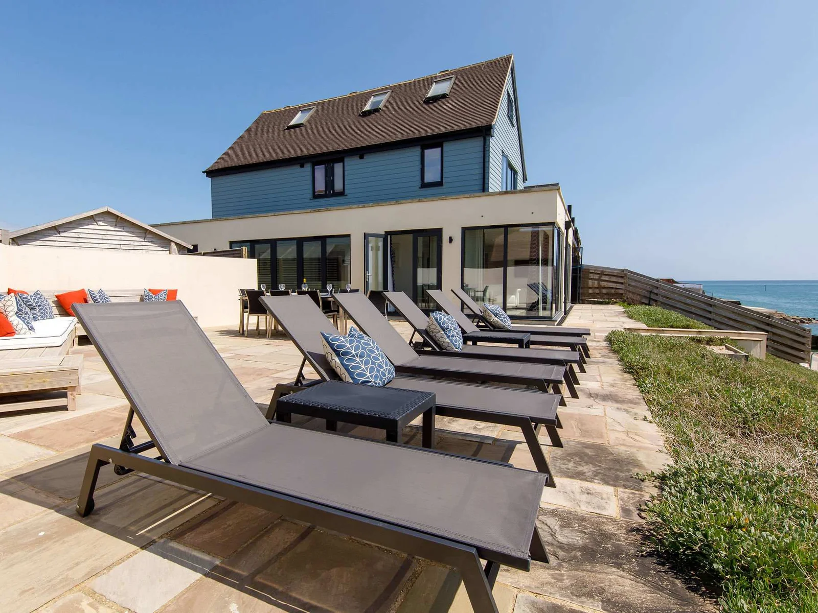 The patio has comfy corner seating, dining furniture and sun loungers.