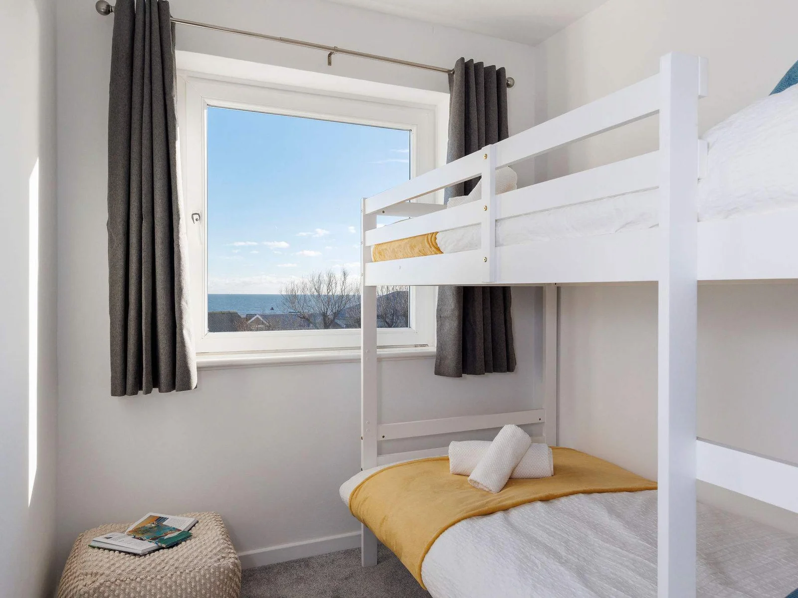 Cozy bunk room with a stunning sea view