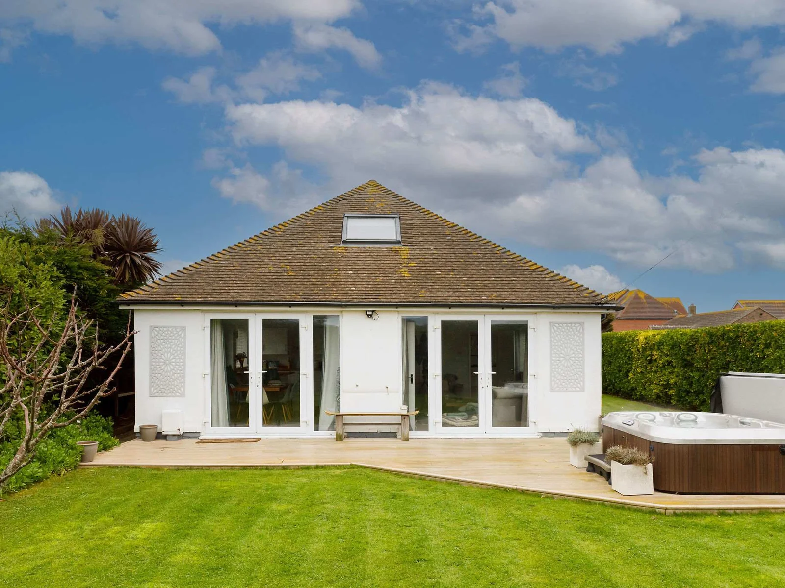 The decked area at the rear of the house leads to lovely lawned garden that children will love playing in.