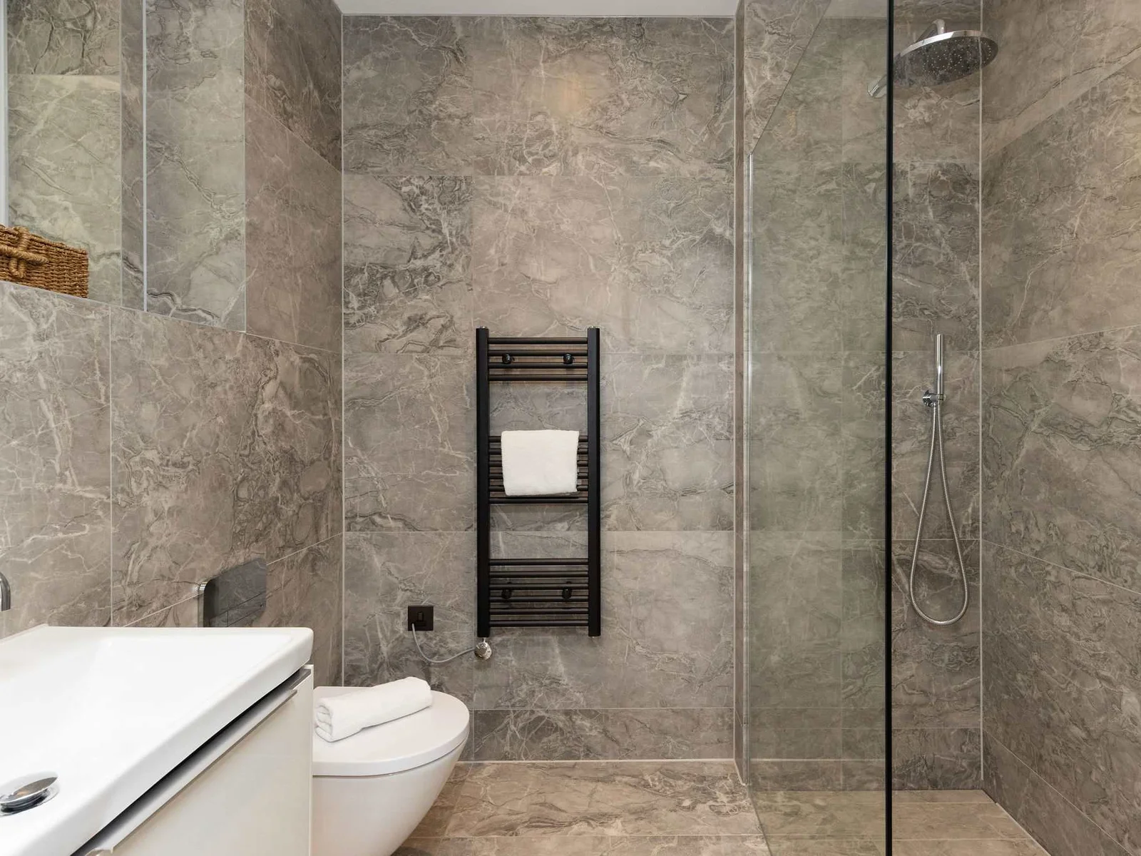 Modern ensuite bathroom with walk-in shower and heated towel rail