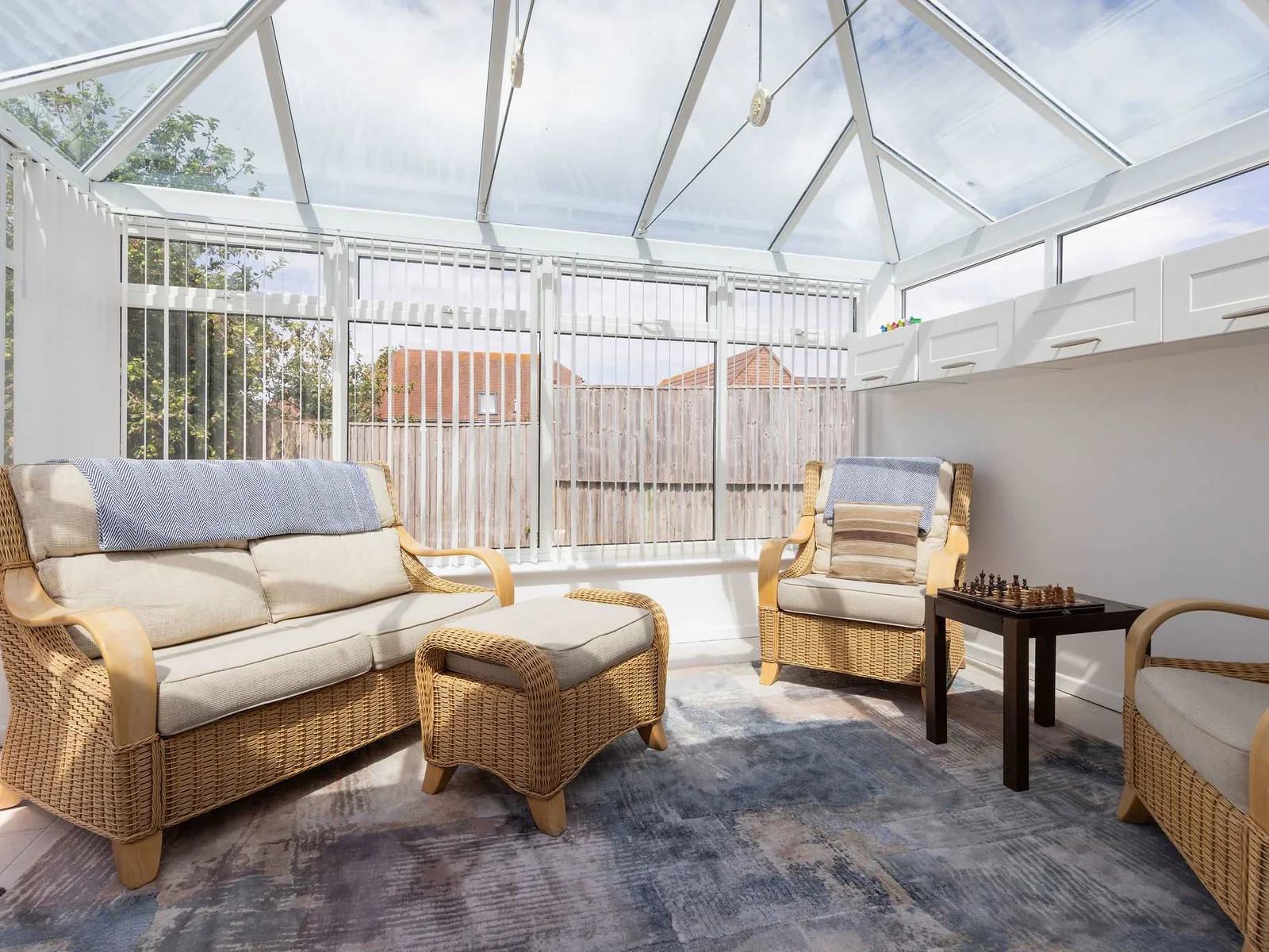 Sunny conservatory with comfy seating for 4