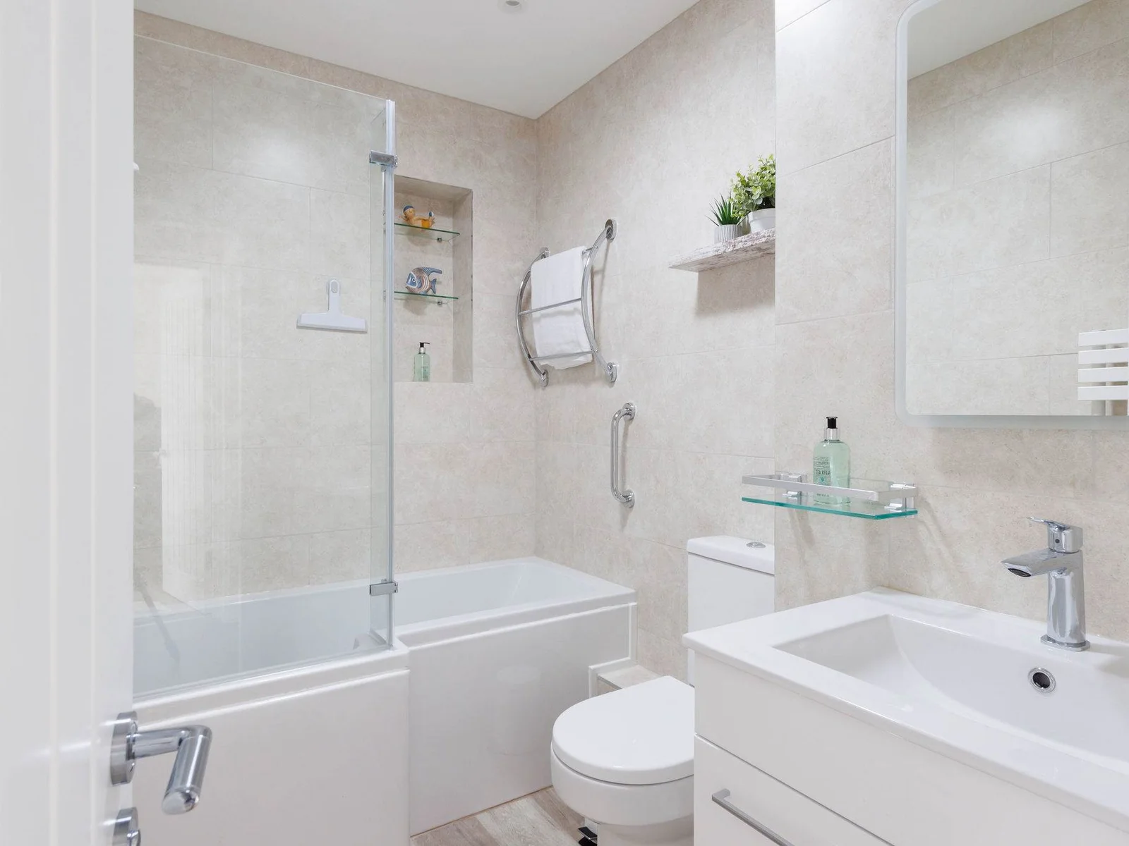The good sized family bathroom has a bath, shower (over bath), WC and sink.