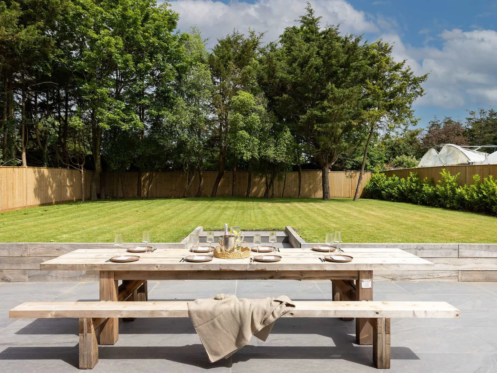 Garden dining area with spacious lawn and countryside surroundings