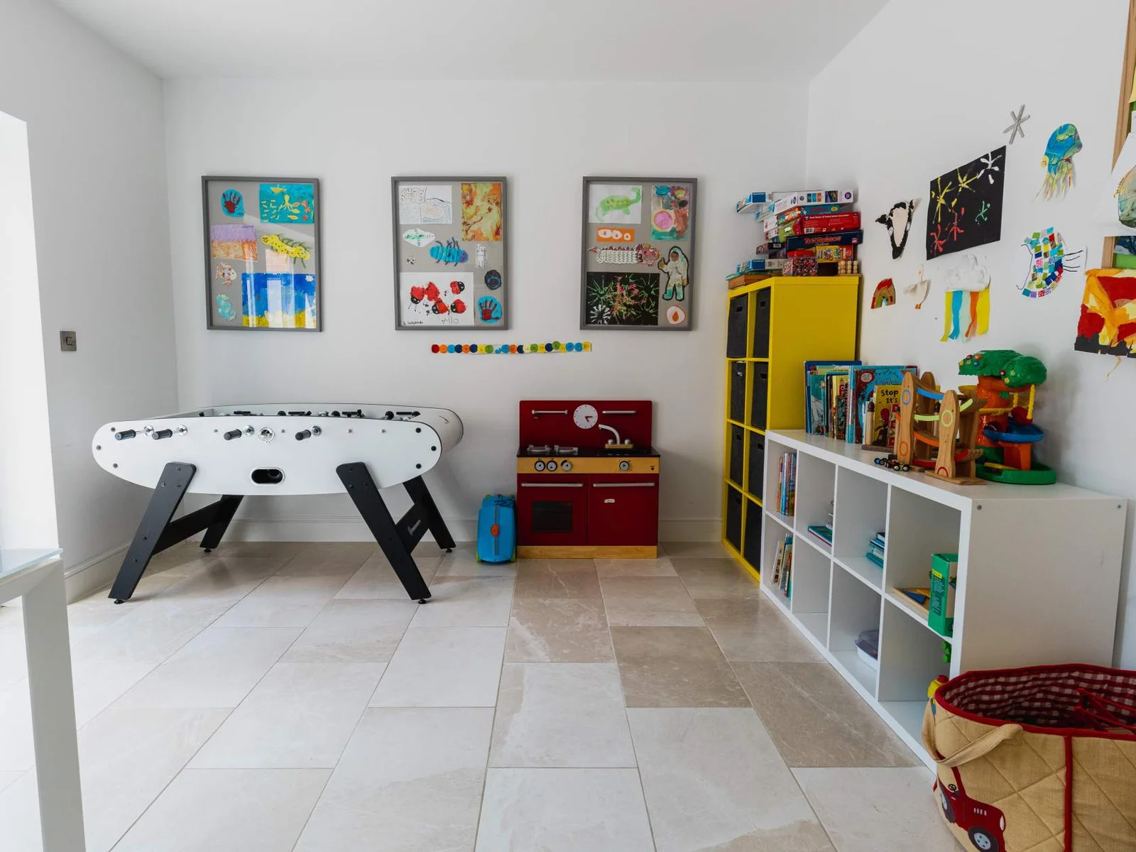 Family playroom with foosball table, toys and storage—perfect for keeping younger guests entertained.