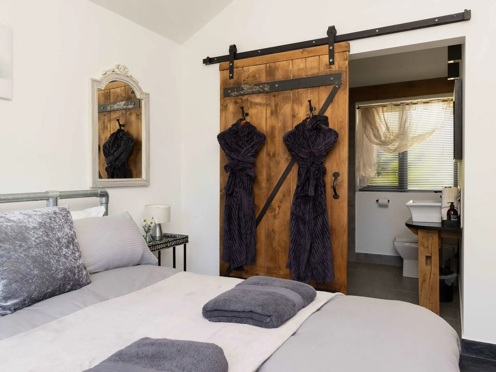 This peaceful sleeping space combines cozy rustic charm with the convenience of an ensuite.