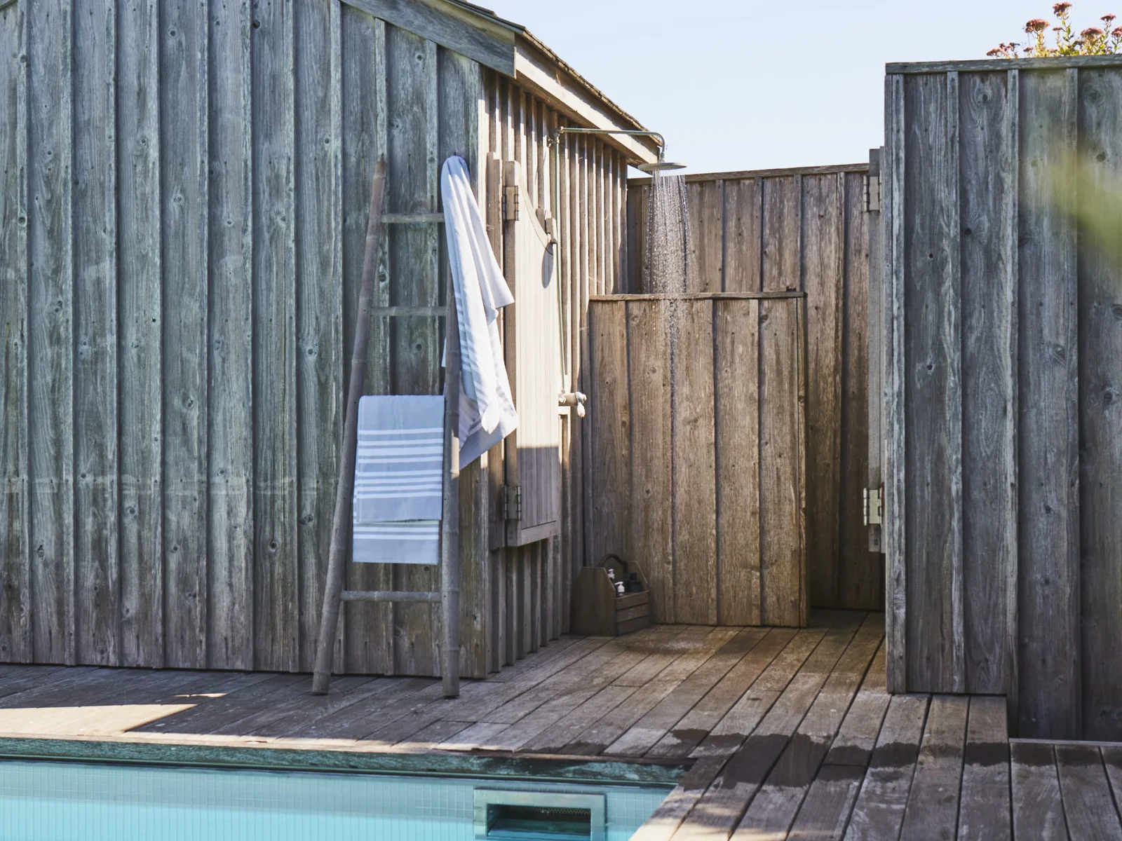 Outdoor shower by the pool, perfect for rinsing off after a swim or a day at the beach