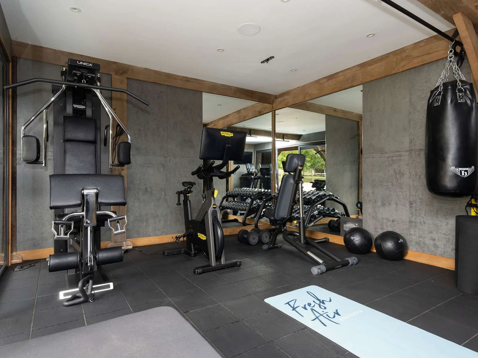 A well-equipped gym with Technogym equipment, free weights and punch bag.