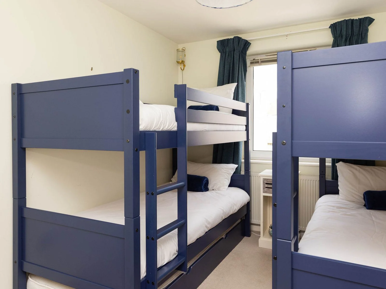 Bunk room with two sets of sturdy wooden bunks