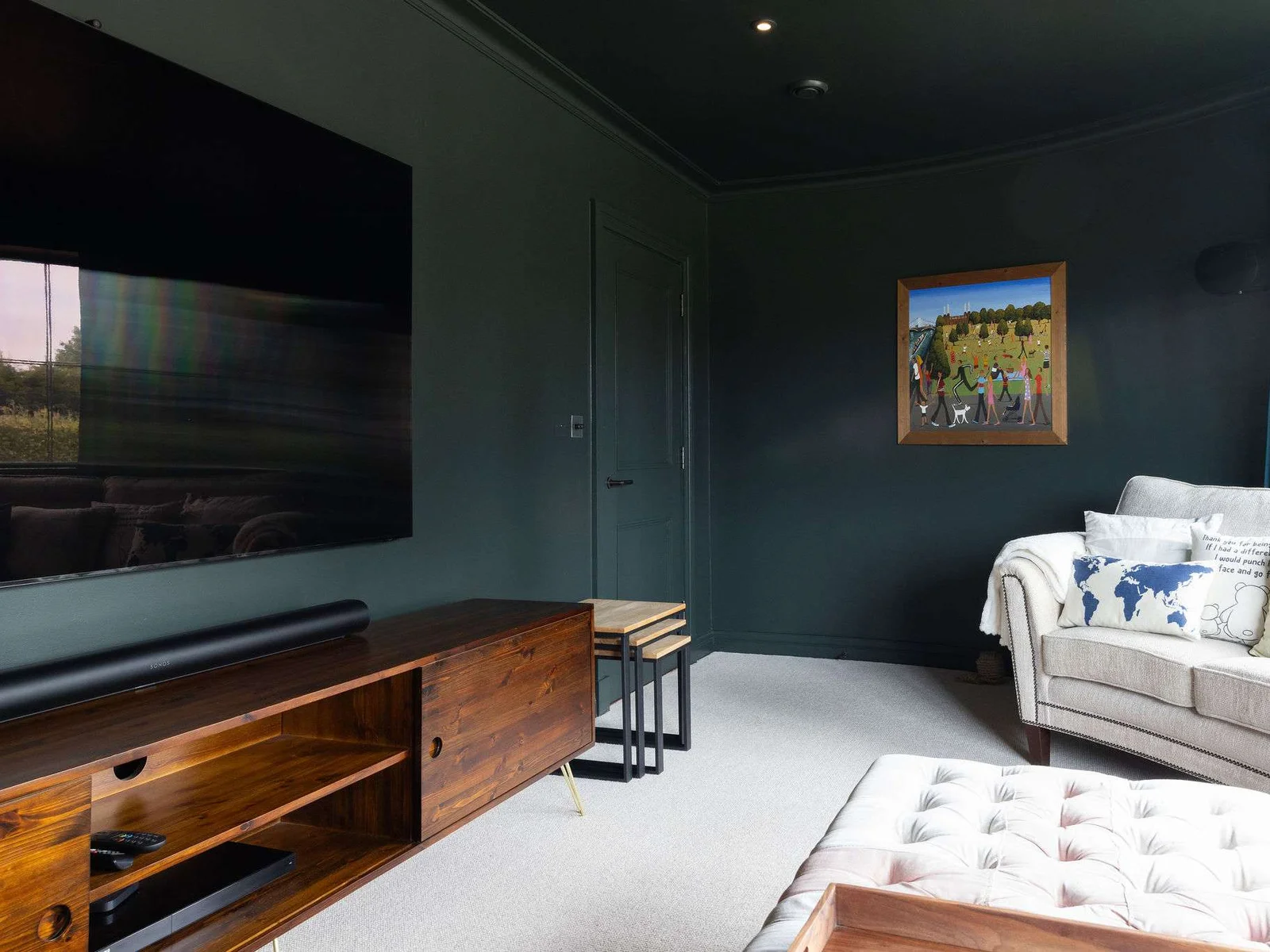 Stylish cinema room with plush seating, and a huge flat-screen – perfect for movie nights.