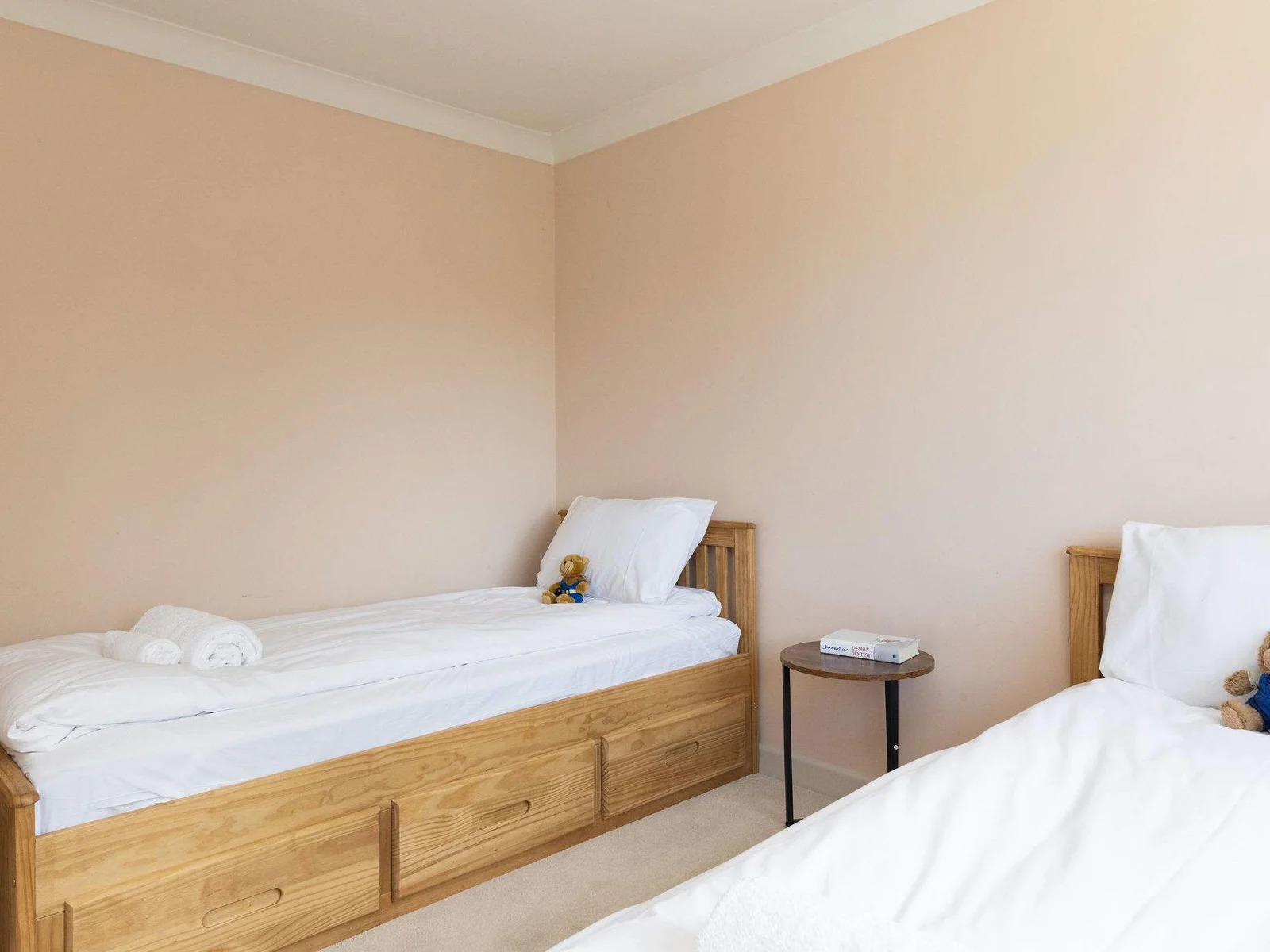 A sweet and welcoming twin bedroom, simply styled to create a calm, comfortable space for a restful night’s sleep.