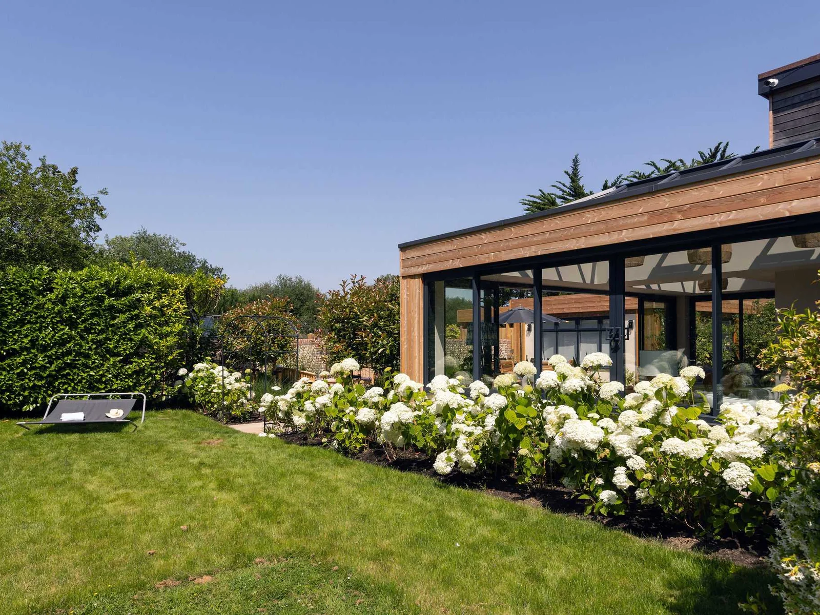 Landscaped garden with manicured lawn, offering a peaceful setting for outdoor relaxation