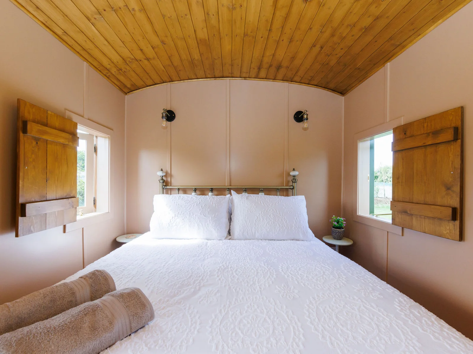 Step into the king room - a charming bedroom with rustic wooden accents and soft linens.