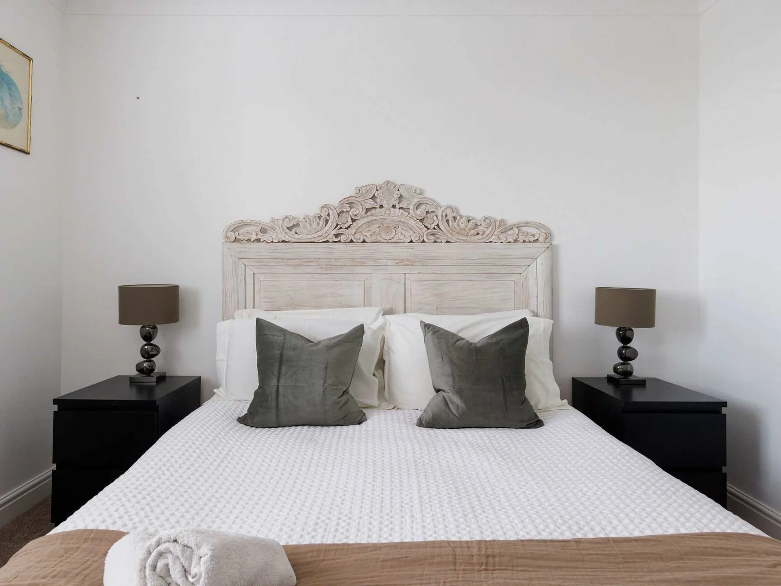 This king room has a beautiful decorative headboard.