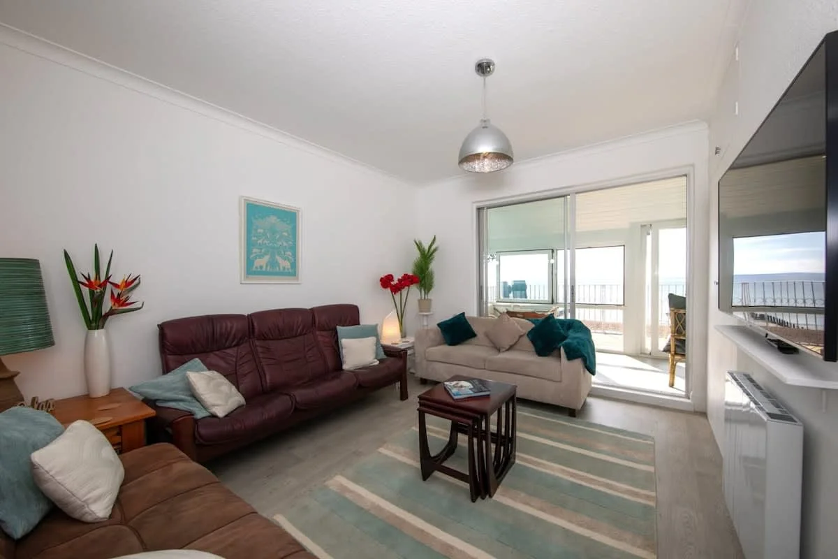 Get comfortable in the living room as you settle in for a movie night on the large wall mounted TV