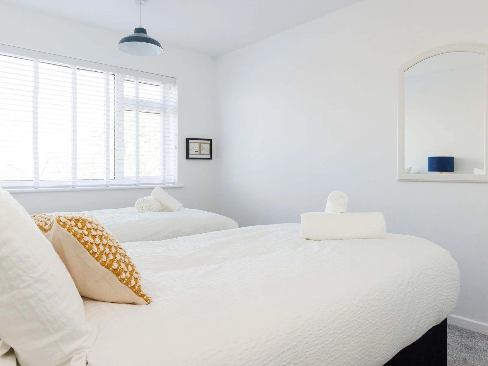 Cozy twin room with soft, inviting bedding.