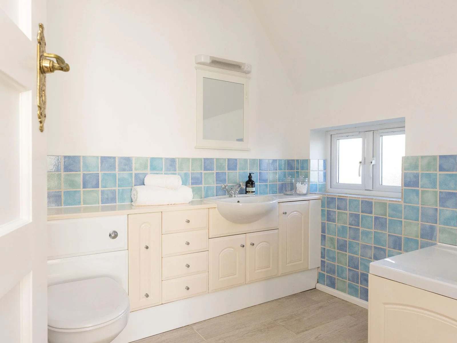 Family bathroom with bath & vanity unit.