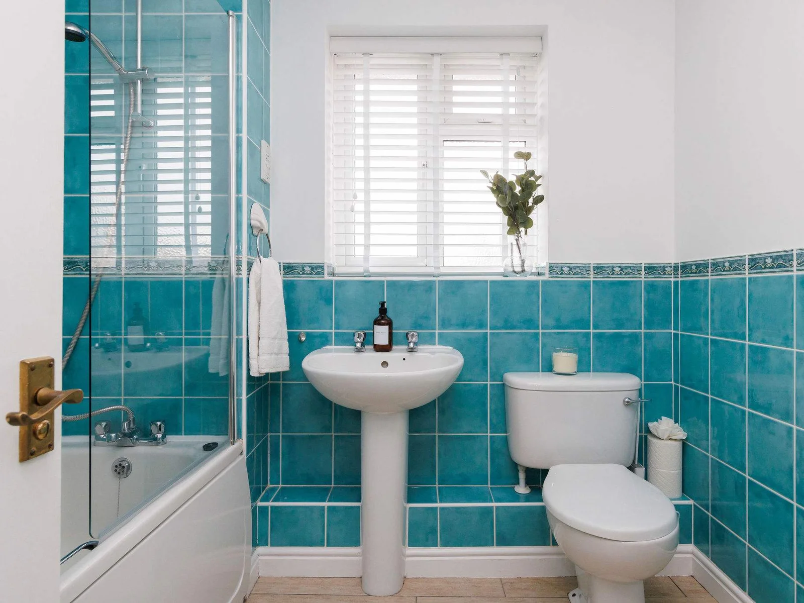 The family bathroom has an over bath shower, WC and sink.
