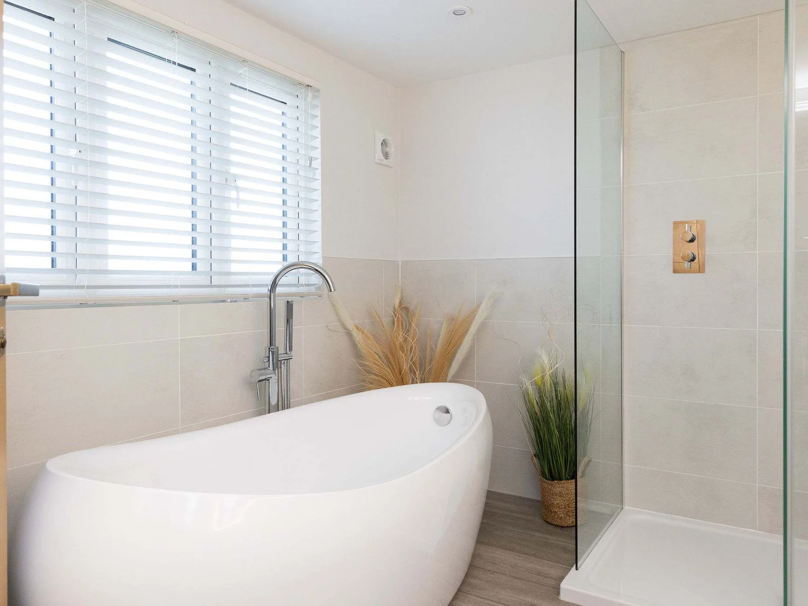 Stylish ensuite with freestanding bath and walk in shower