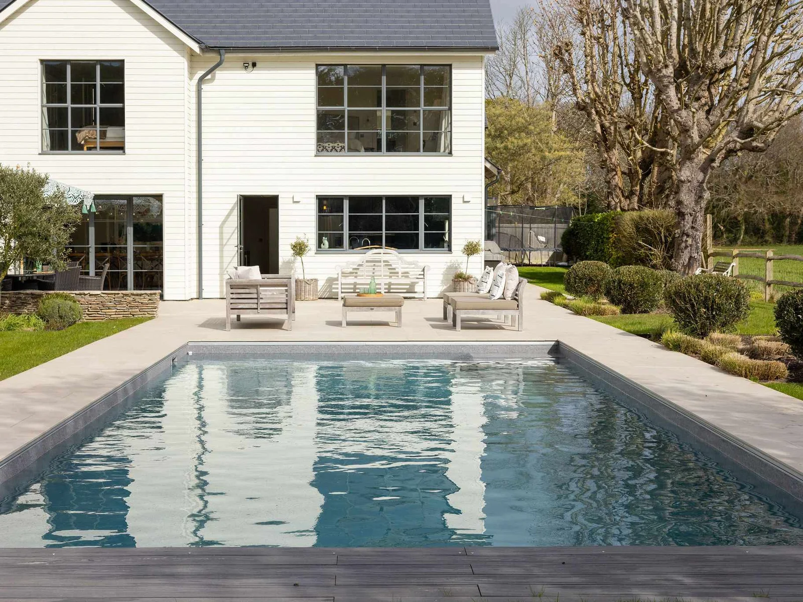 Impressive exterior with heated pool, stylish outdoor seating, and a stunning architectural backdrop.