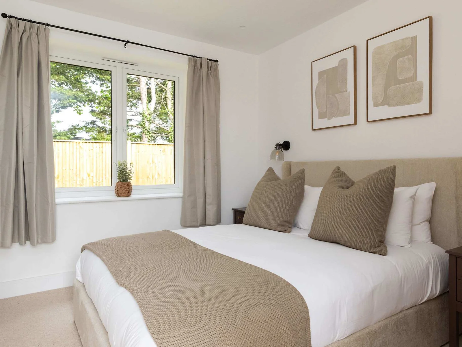Comfortable bedroom with natural light and garden views