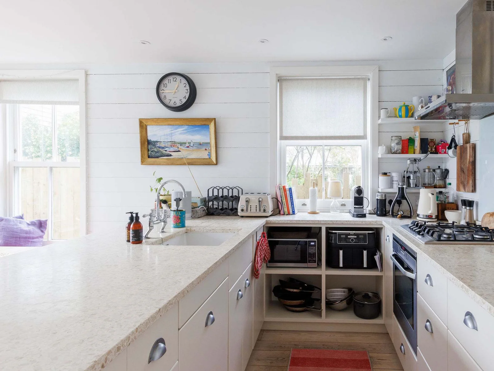 Prepare delicious meals in our fully equipped kitchen, featuring a large island and ample storage