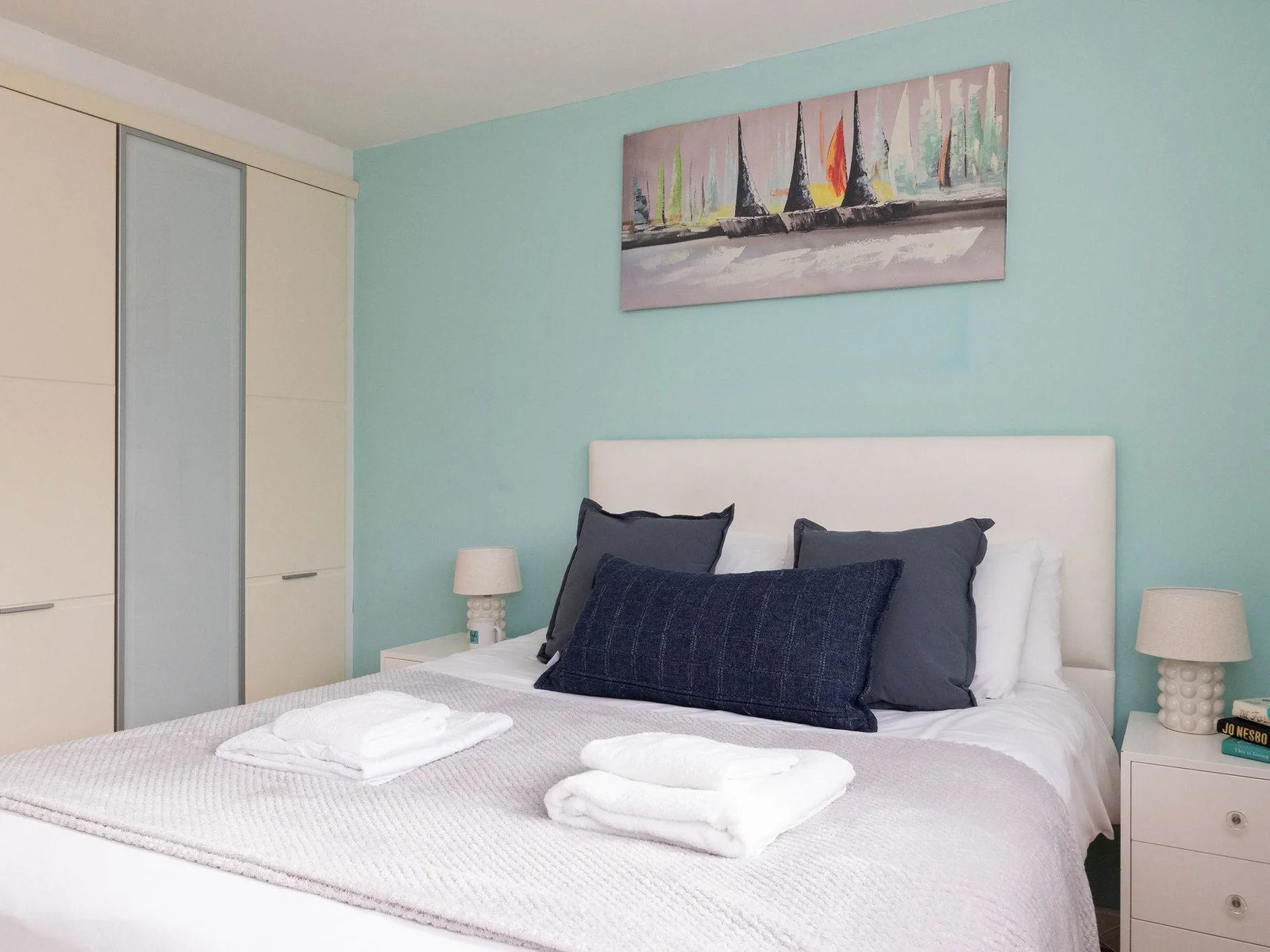 Calming double bedroom with soft coastal décor, fresh linens, and ample storage for a comfortable stay.