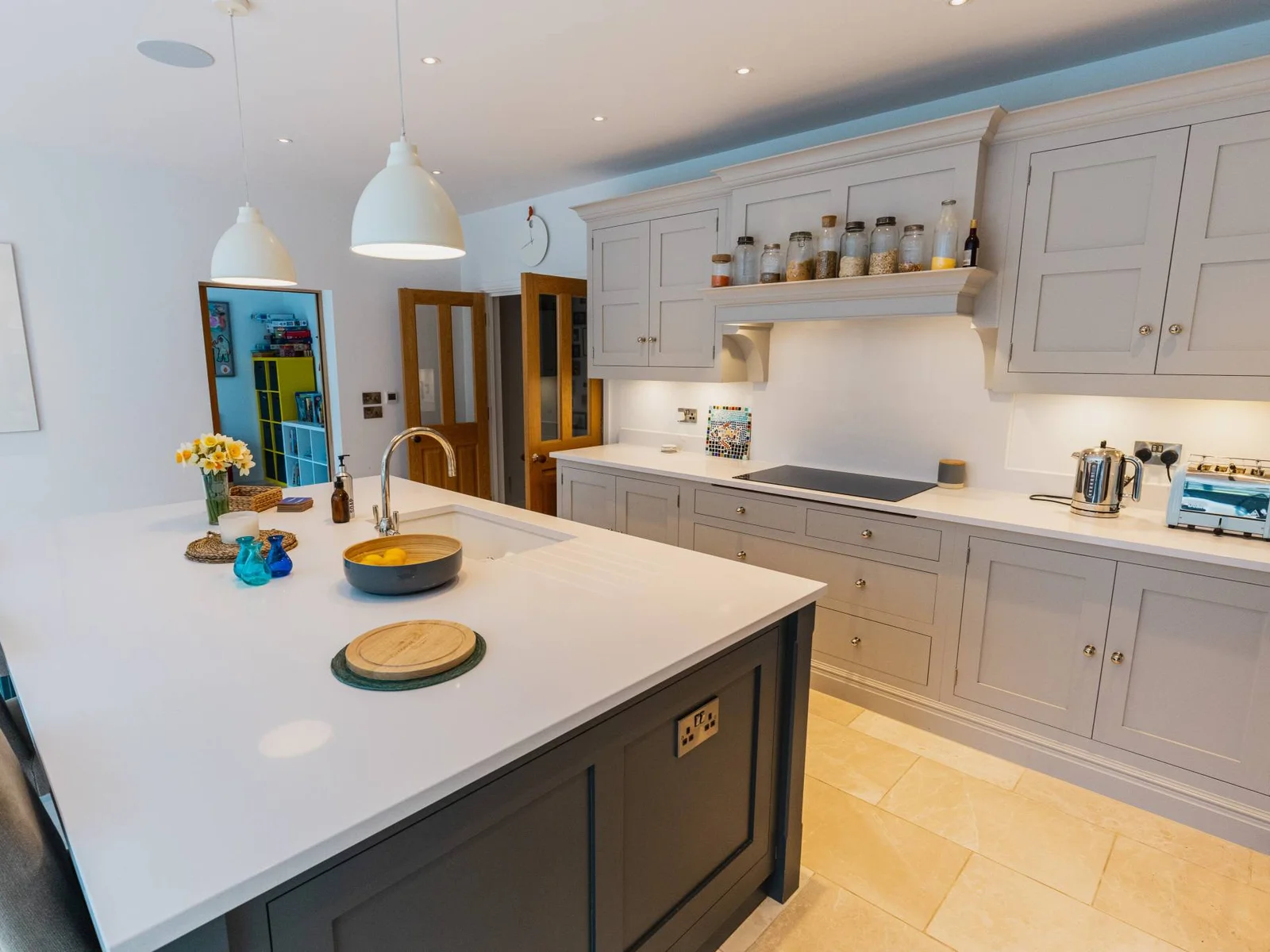 Stylish fully equipped kitchen with large island, pendant lighting and modern appliances, ideal for cooking and socialising.
