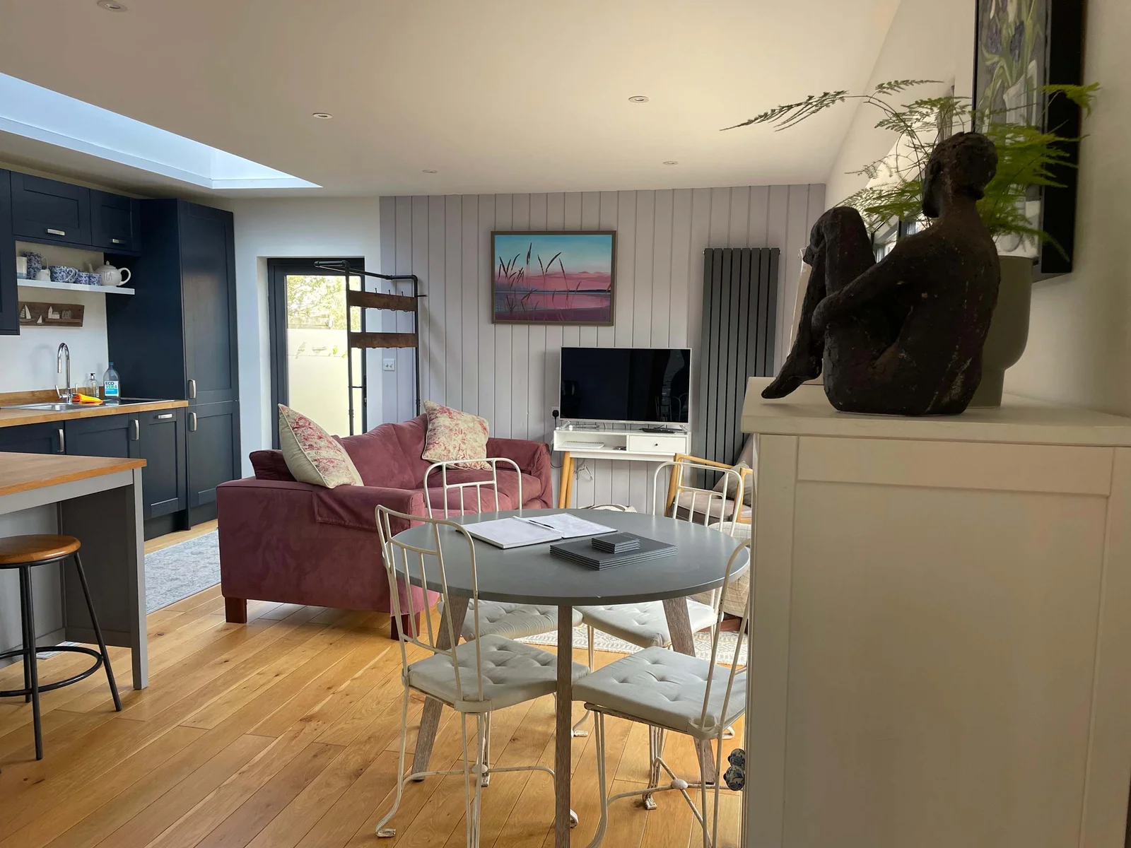 The open plan kitchen, living and dining space is homely and cosy, with different areas to sit and relax.