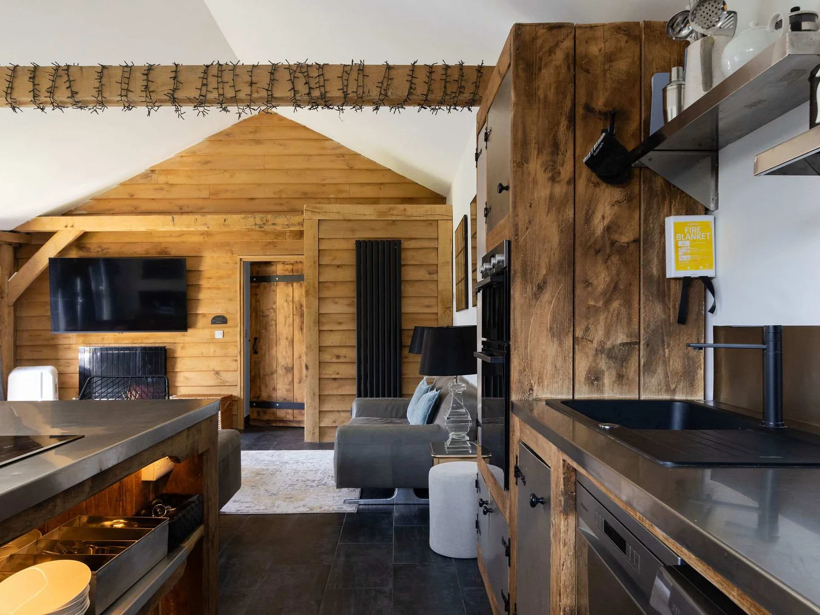 An intelligent open-plan layout connects the modern cooking workspace directly with cozy home comforts.