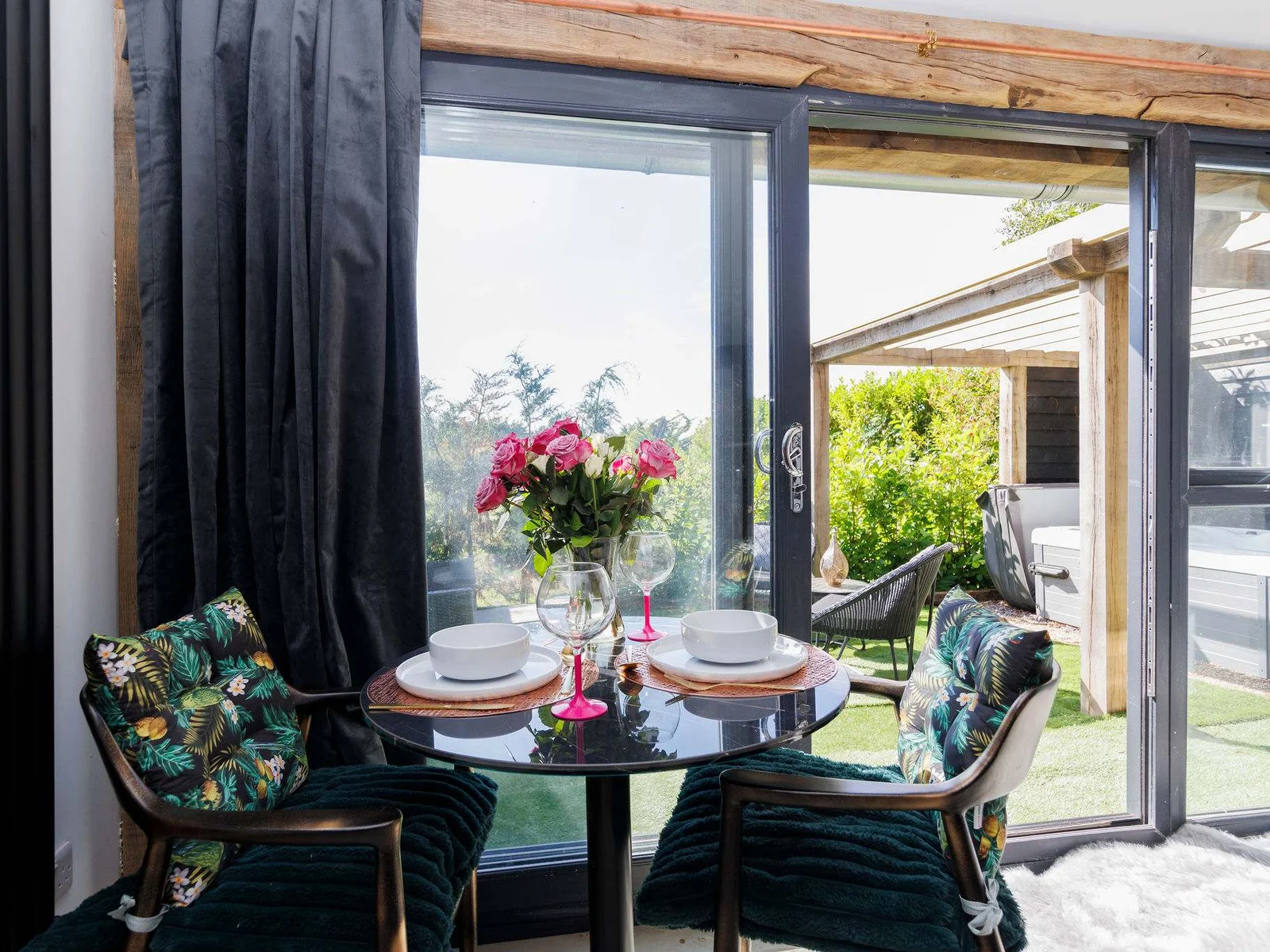 Dining at a table for two while enjoying the view of the greenery, creates a romantic and relaxing atmosphere.