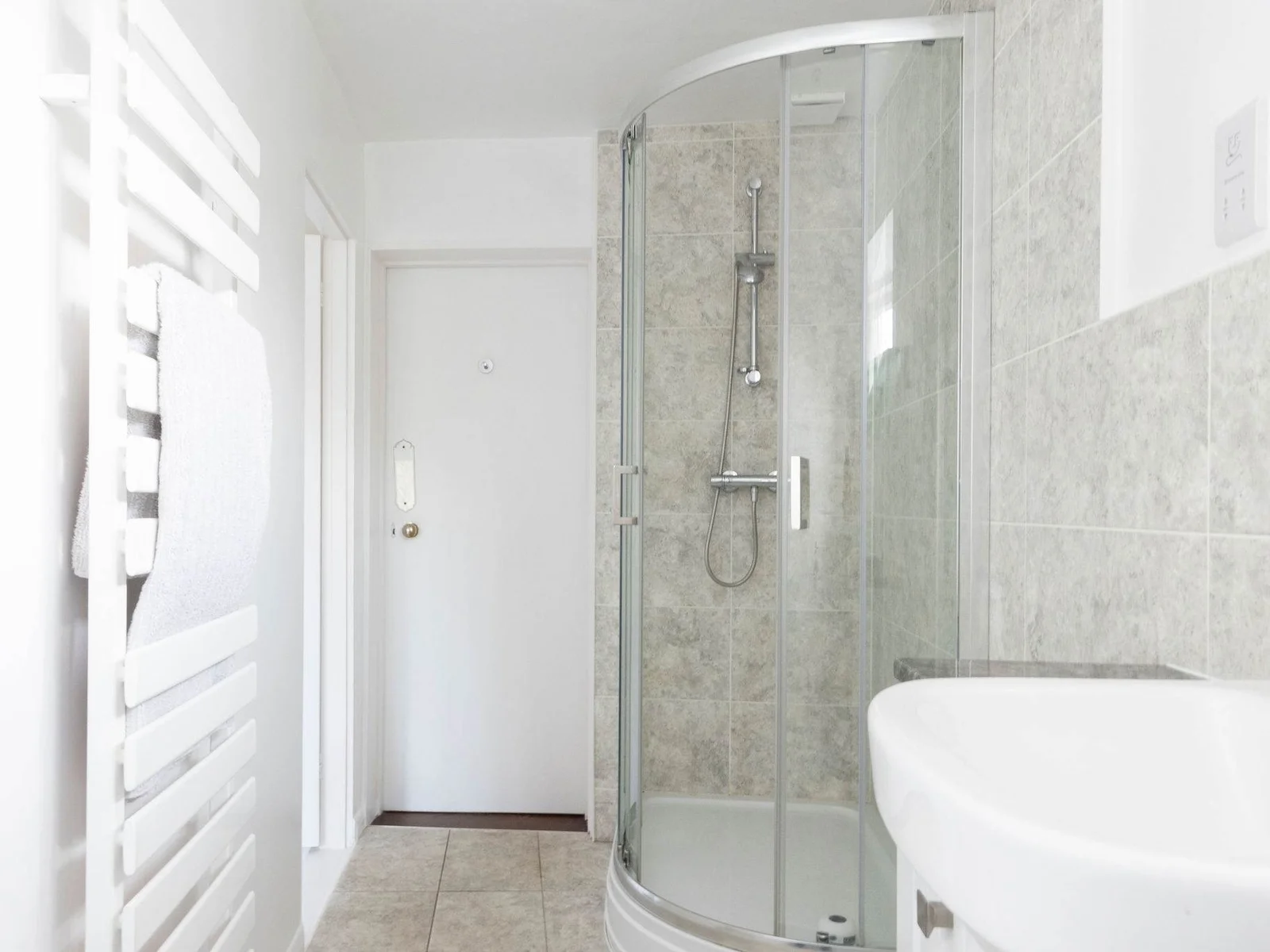 A sleek glass-enclosed shower with a modern touch
