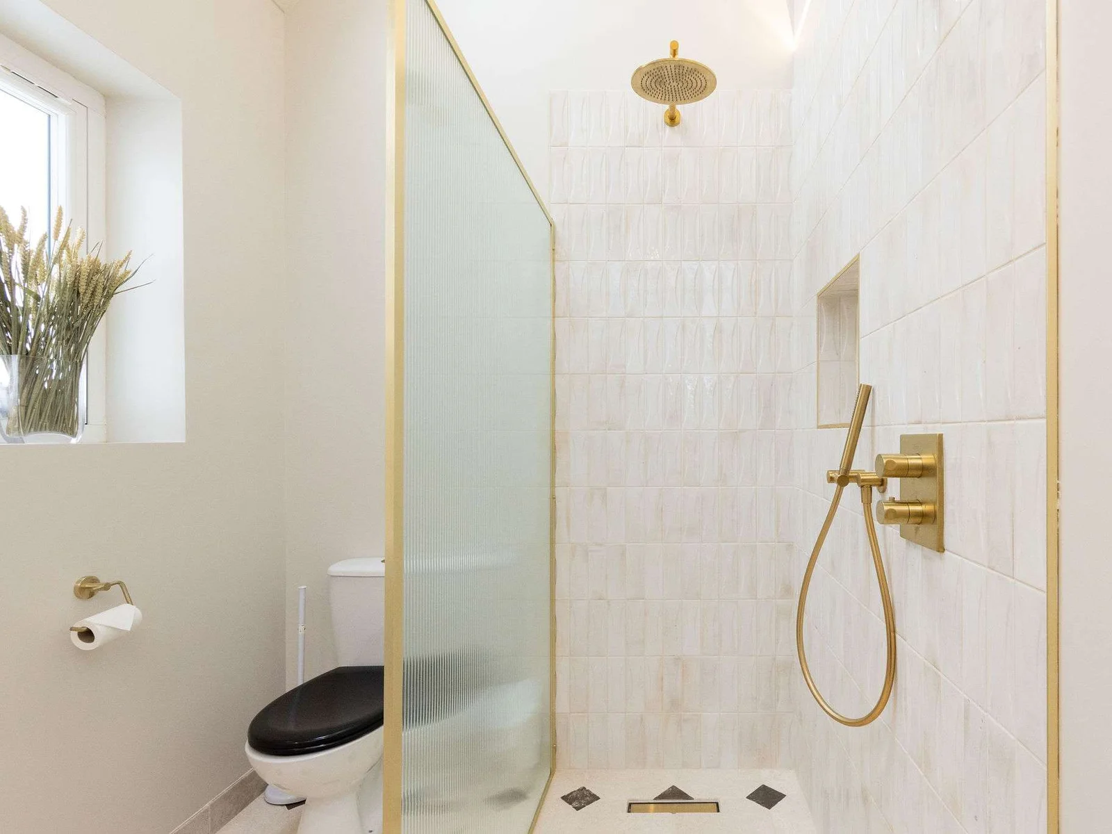 A modern family bathroom with a walk-in rainfall shower.