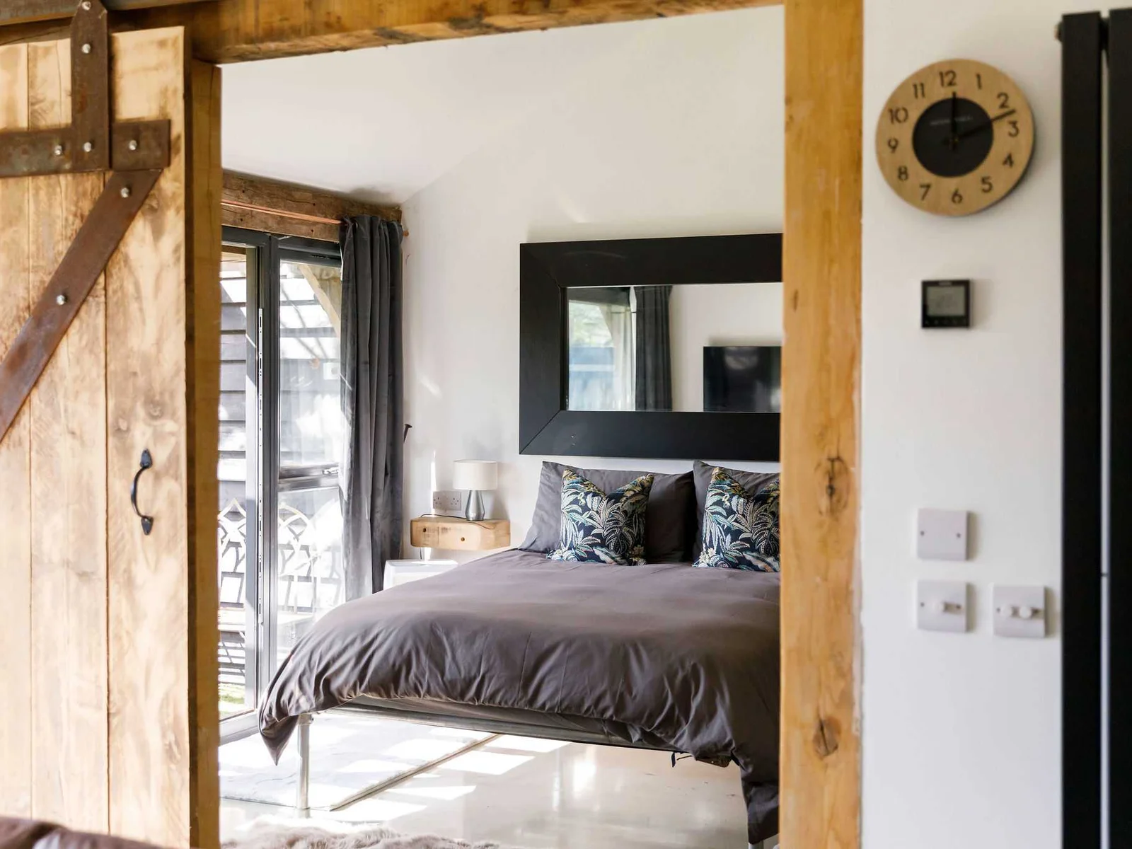 Open up the pocket door into the contemporary master bedroom.