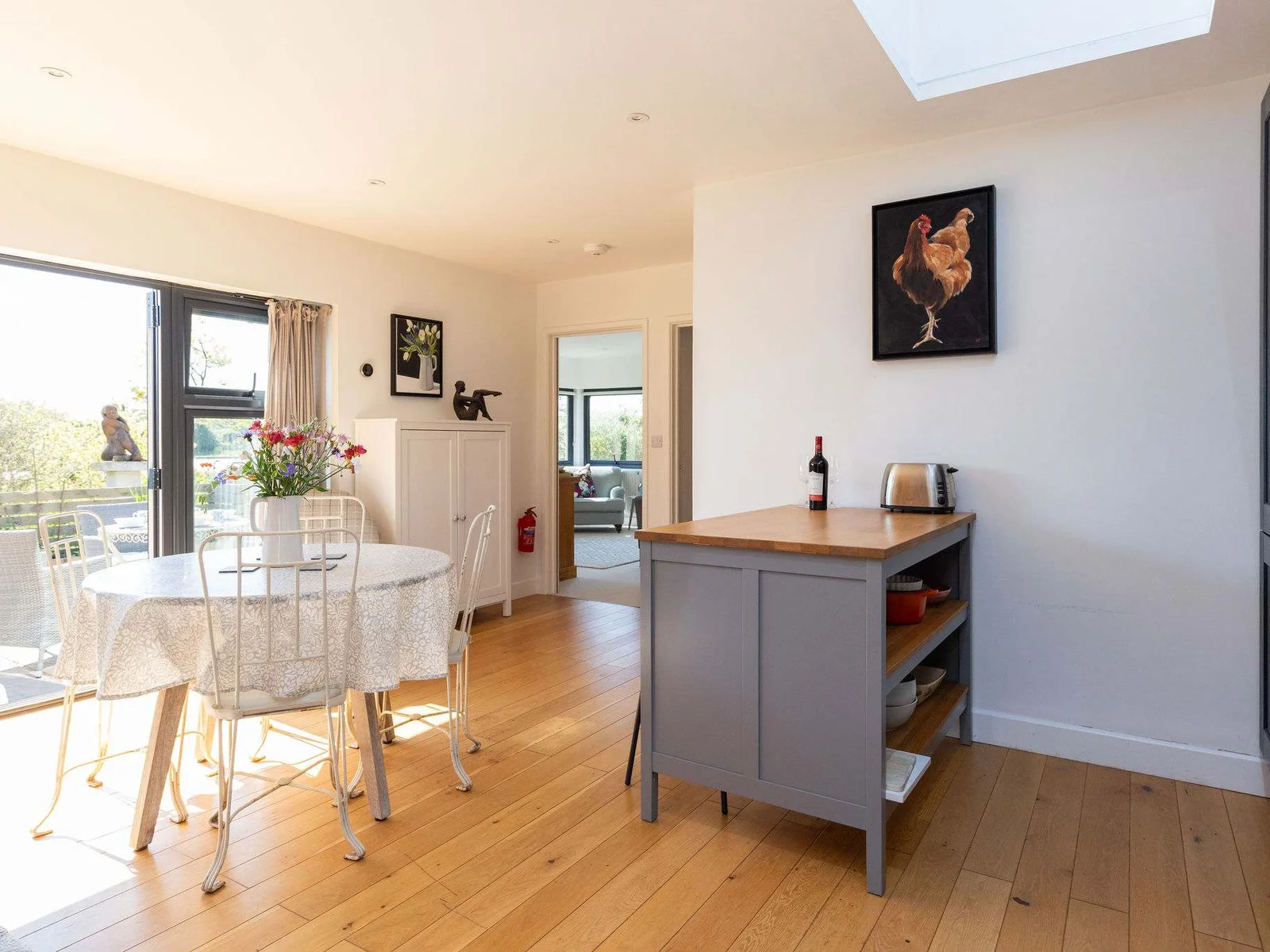 A bright and inviting kitchen and dining space with a stylish grey island.