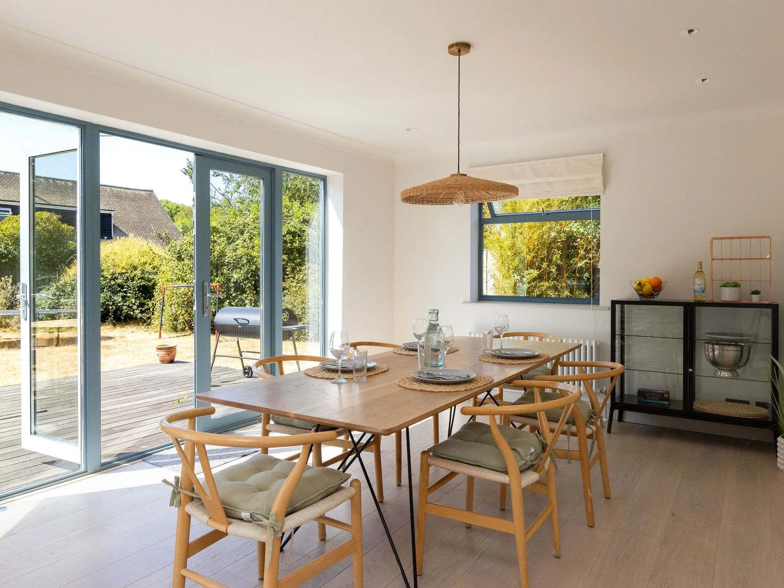 A beautifully bright, contemporary open-plan kitchen and dining space, with a stylish table comfortably seating six — perfect for relaxed breakfasts, long lunches and memorable meals together.