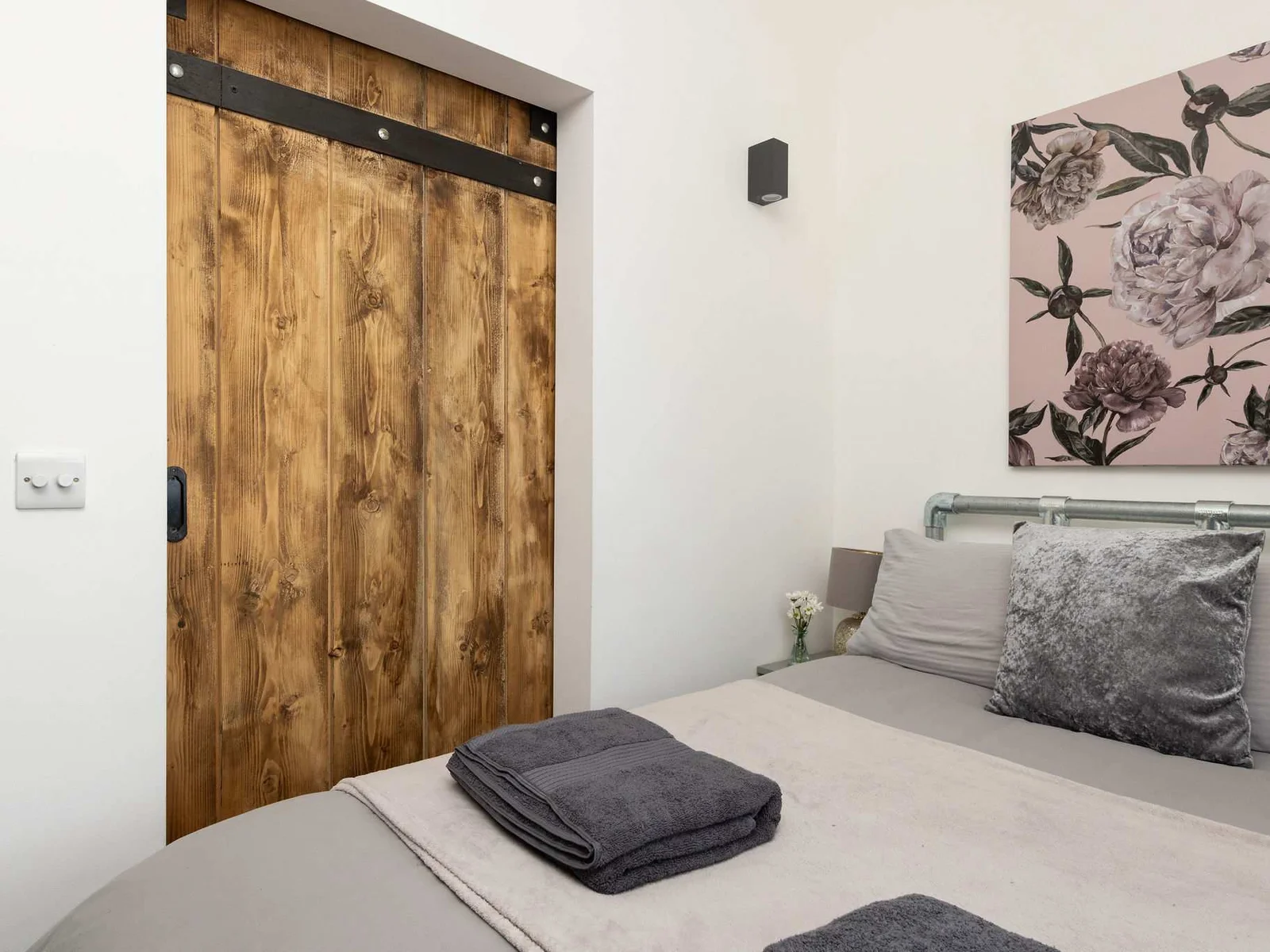 Tasteful furnishings and gorgeous wooden details create a wonderfully cozy bedroom retreat.