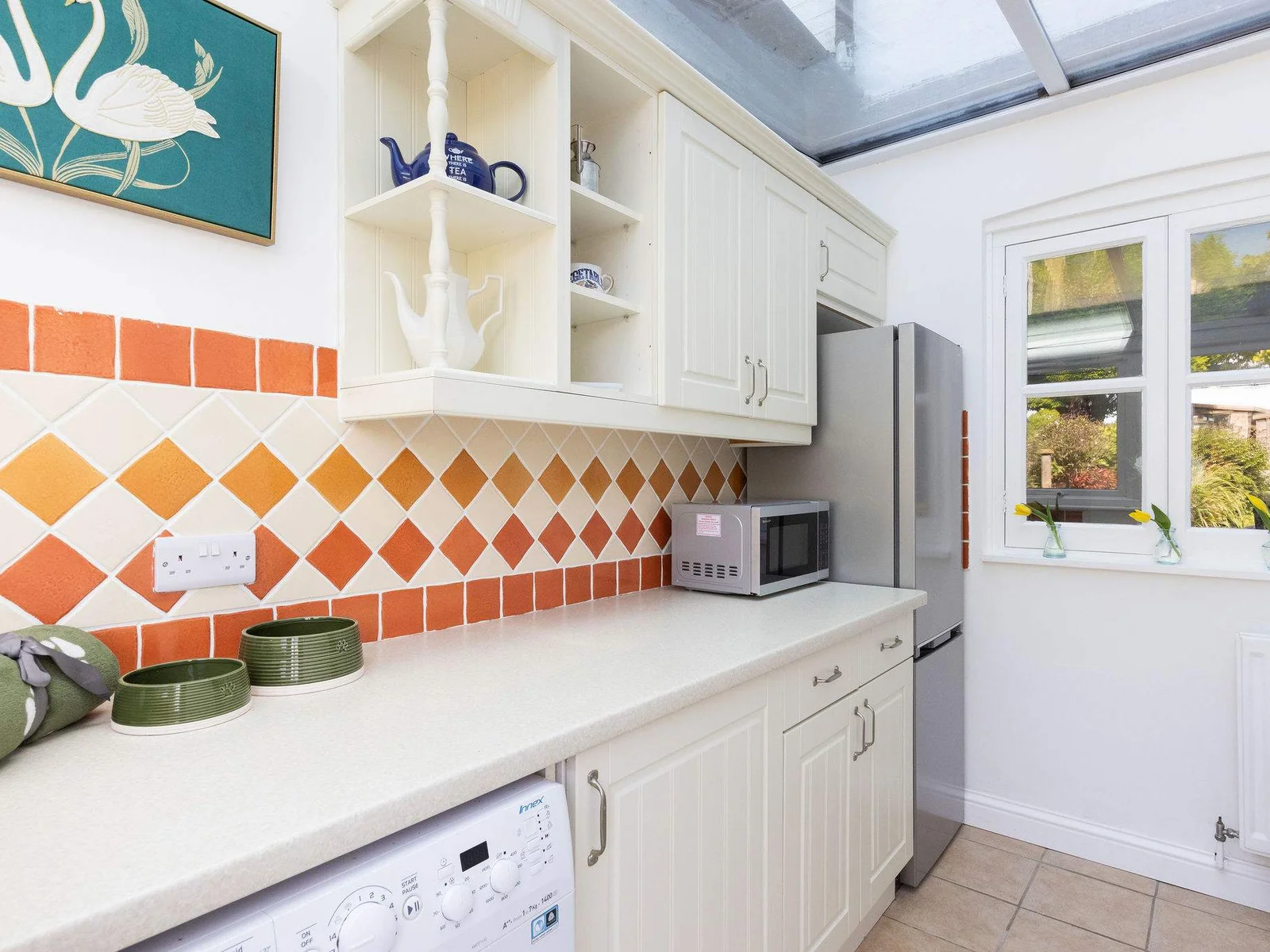 The utility has a full sized fridge freezer and microwave.