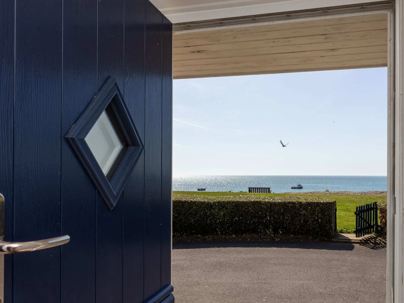Welcoming entrance opening to breathtaking seafront views and your unforgettable beachfront holiday home.