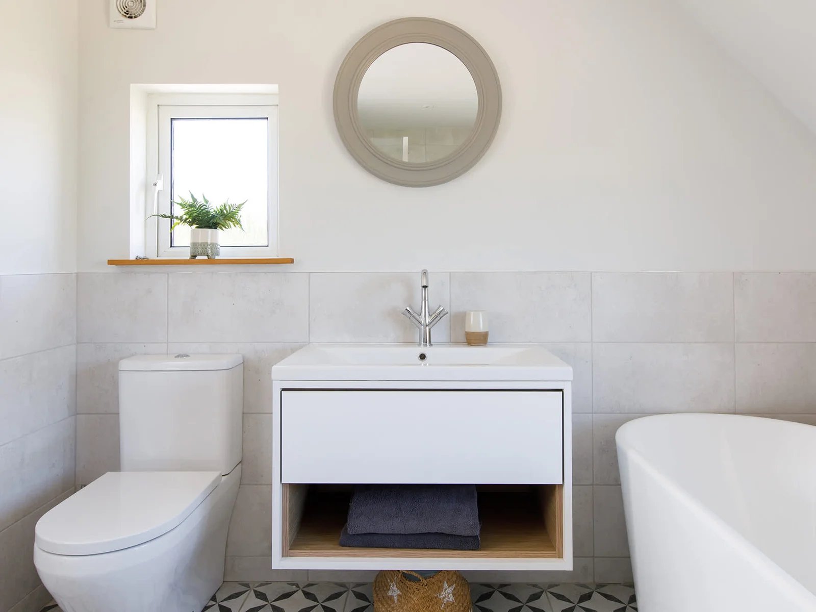 The master bedroom's ensuite had a deep, freestanding bath and vanity cabinet with sink and WC.