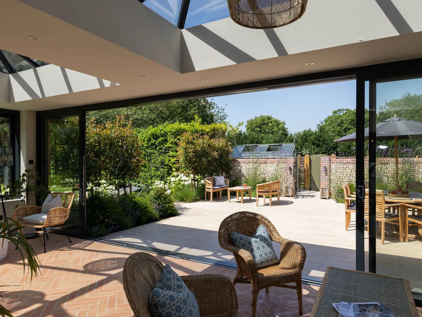 Open-plan conservatory overlooking the outdoor dining terrace, perfect for effortless indoor-outdoor living