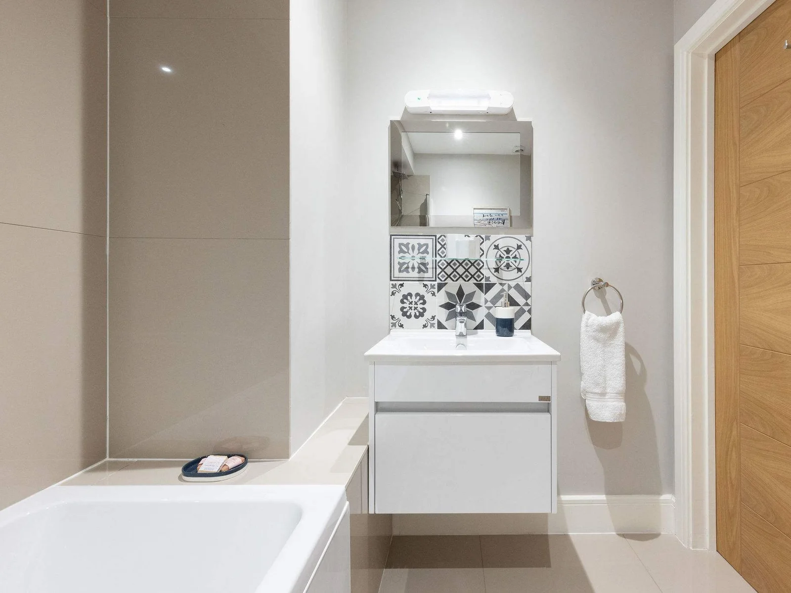 Modern family bathroom with stylish vanity, offering added comfort for your seaside holiday