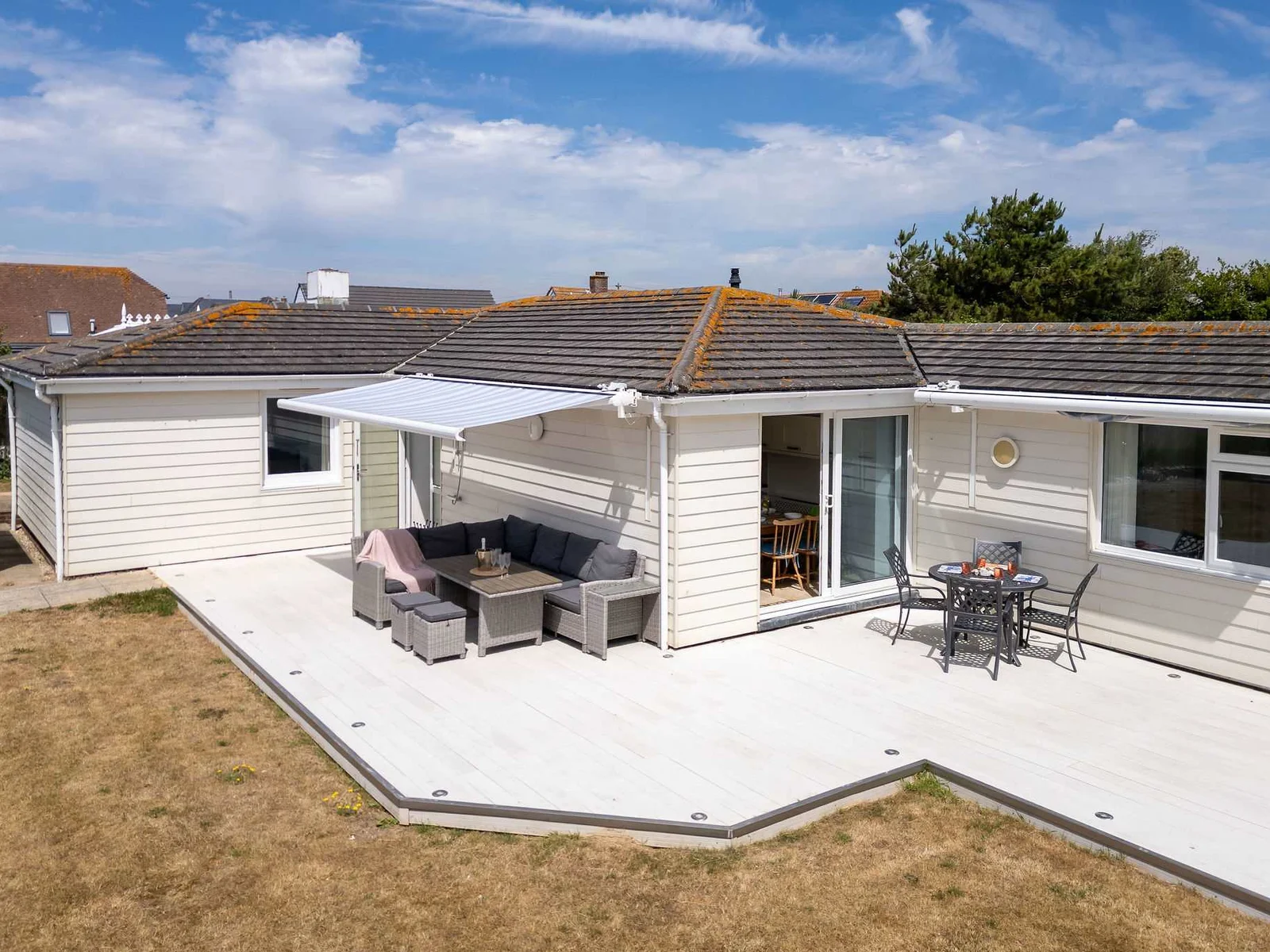 Spacious private terrace with dining and lounging areas – perfect for sunny days