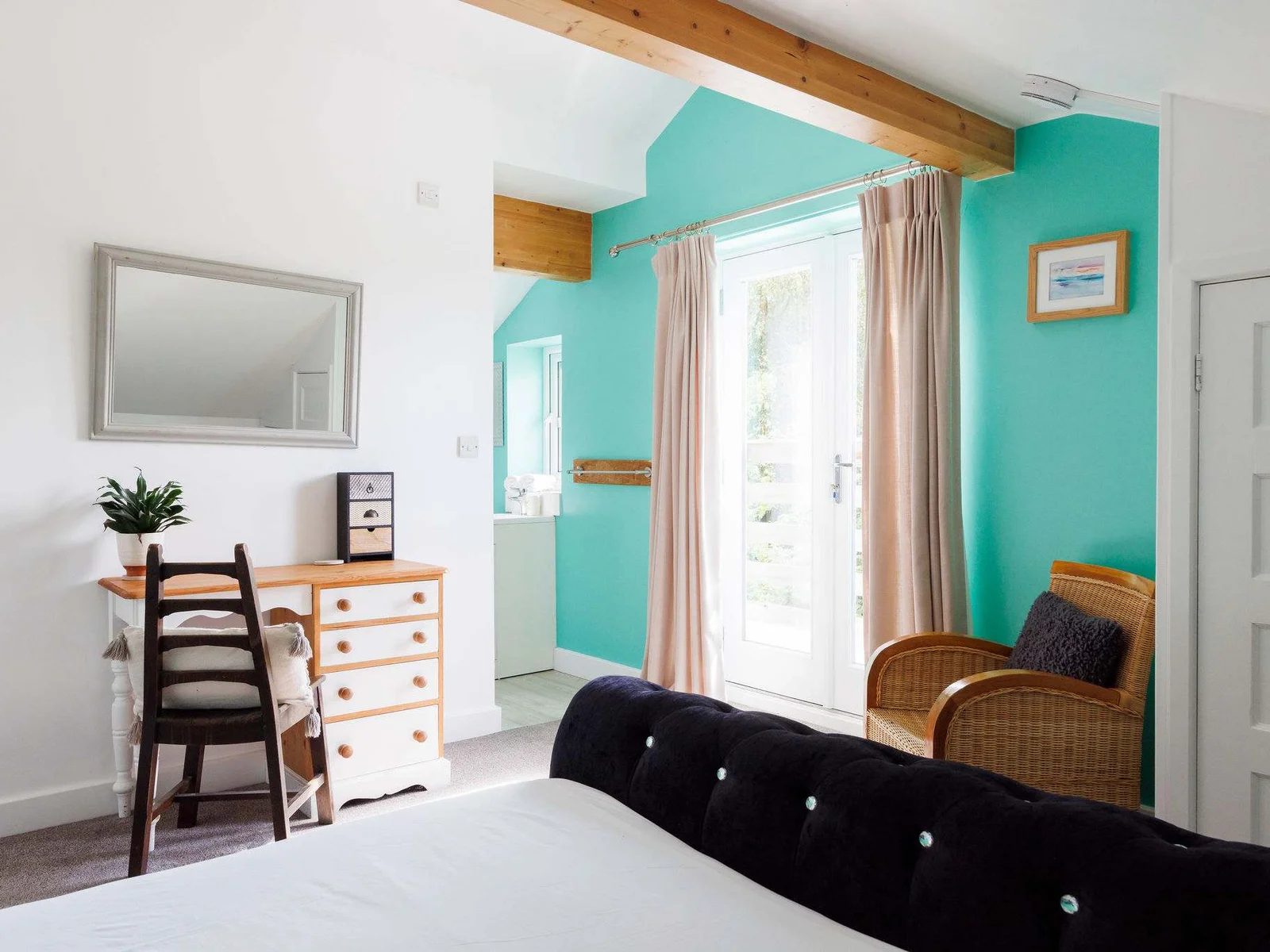 The master bedroom features a plush king bed, bright colours and elegant touches.